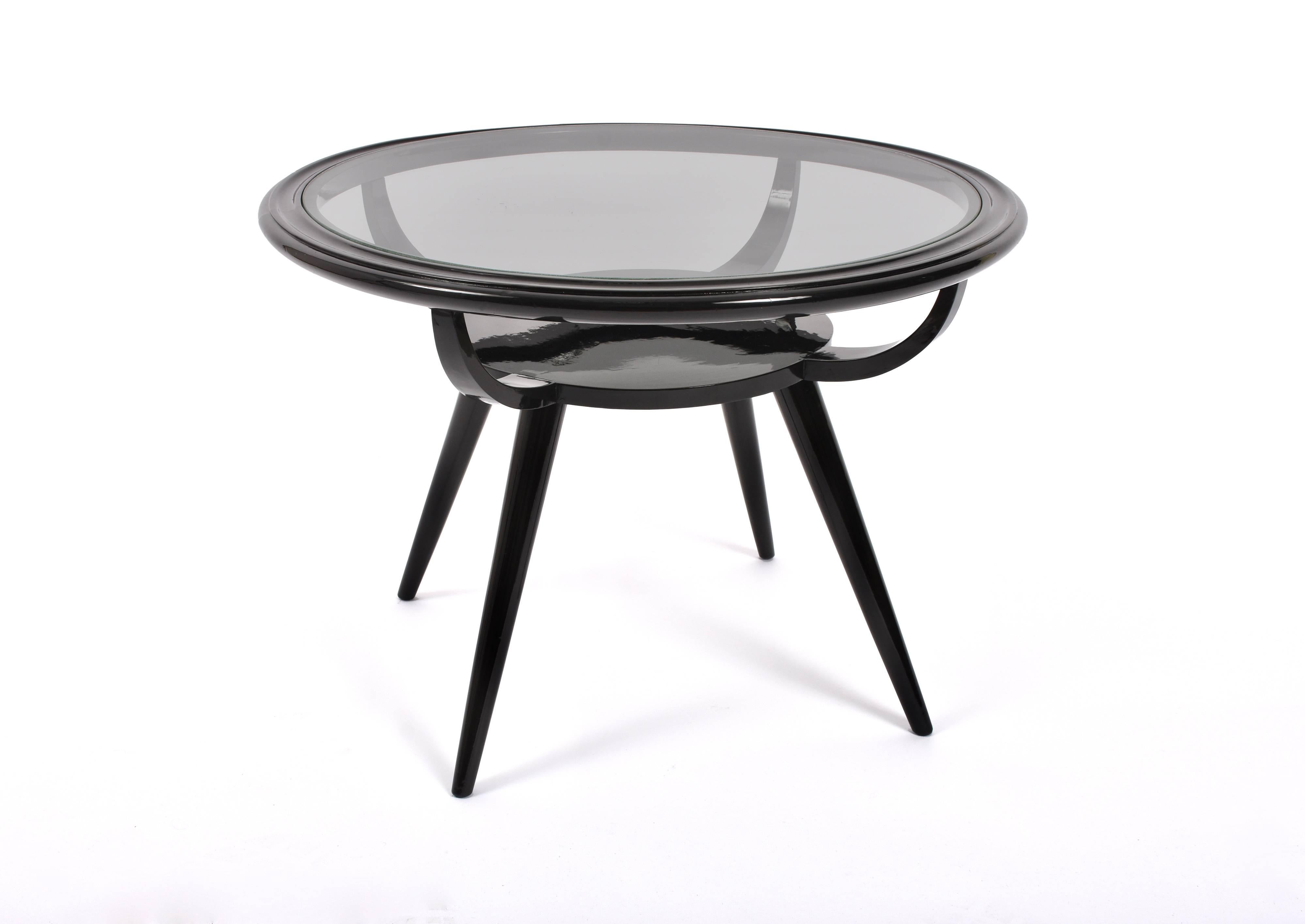 Italian coffee table Art Deco 1940s round wood lacquered black glass top.
In the style of Ico Parisi
Professionally restored.