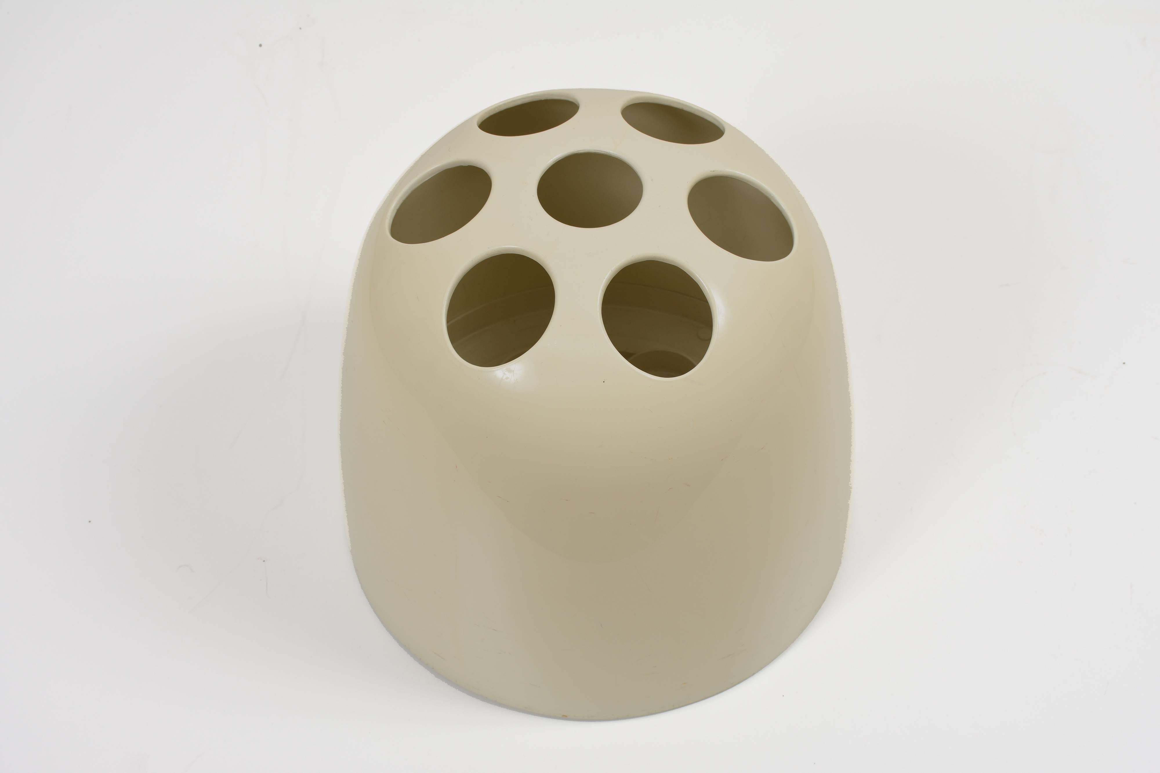 This umbrella stand, model Dedalo, was designed by Emma Gismondi Schweinberger and manufactured by Artemide in 1966. It is made from ABS plastic in cream. The original object was produced in three different sizes: small pencil holders (Dedalino),