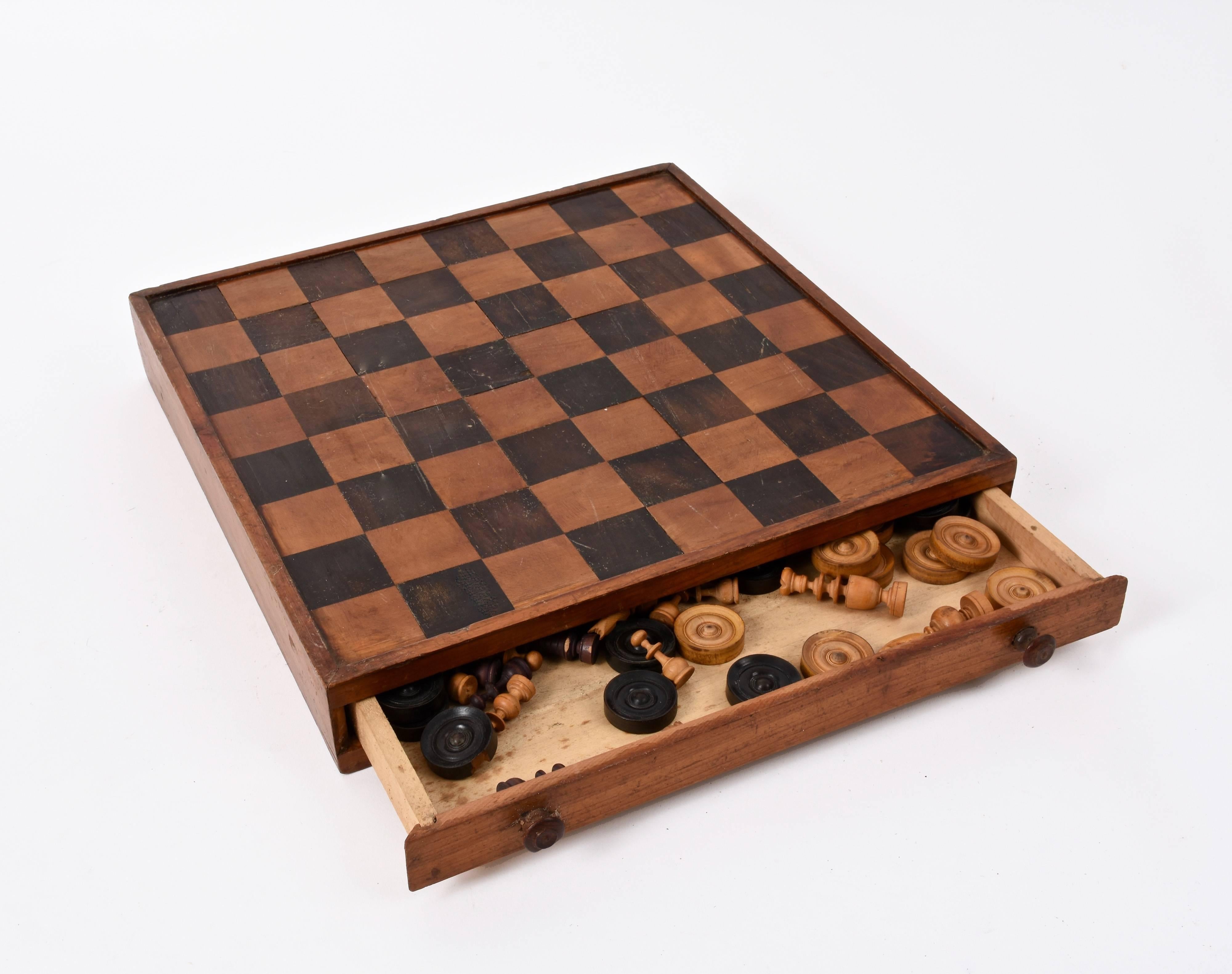 A 19th century handmade games box. Chess or checkers game boards. The game box comes with the 32 and 24 chess pieces included. It is one of the most interesting boxes we have seen.