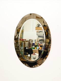 Specchio ovale di metà secolo in Cristal Arte con doppia cornice smussata in bronzo, anni '60
