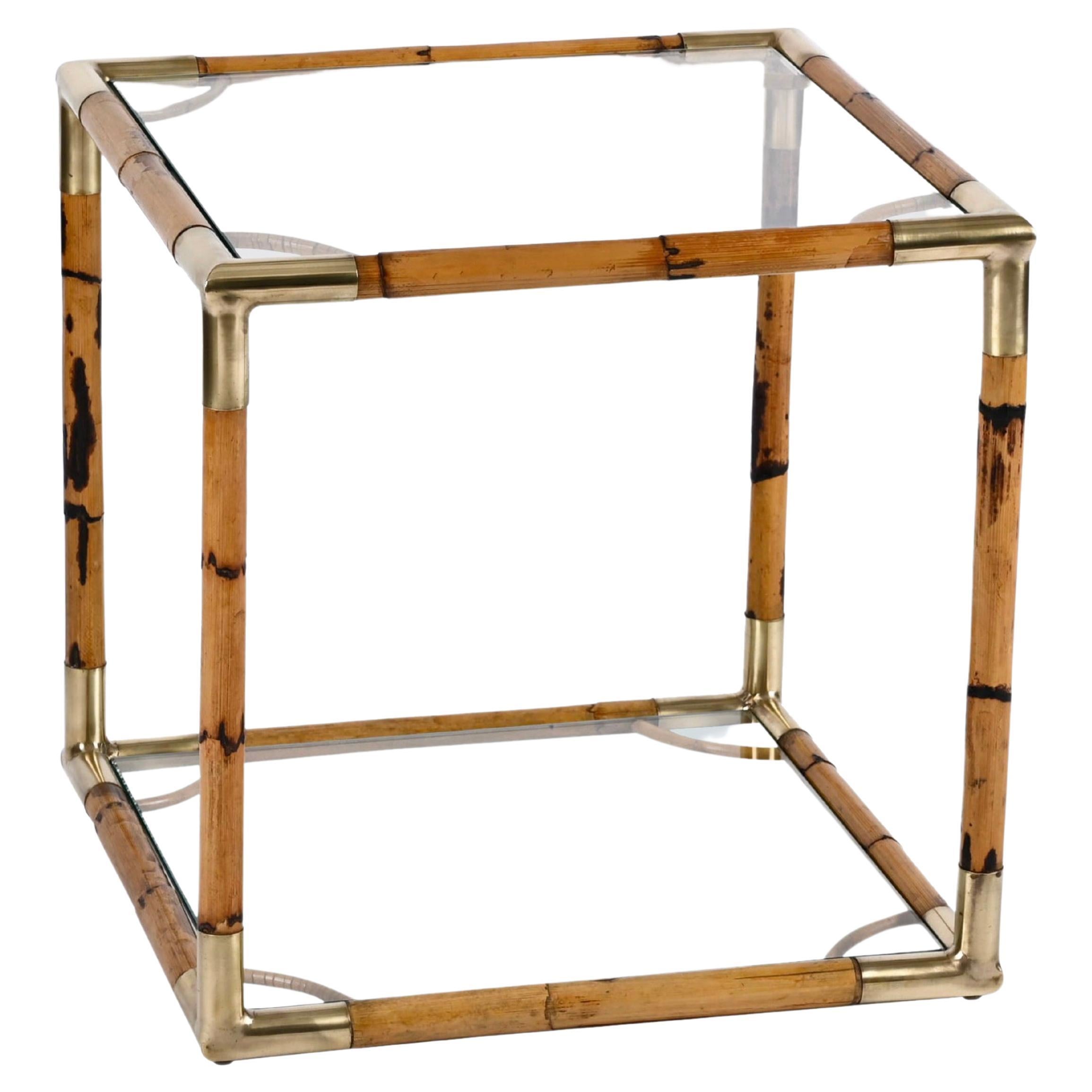 Incredible midcentury bamboo, brass and crystal glass cubic coffee table. This fantastic piece was designed in Italy during the 1960s.

The solid structure of this astonishing table, made of bamboo straight lines kept together by the glass shelf and