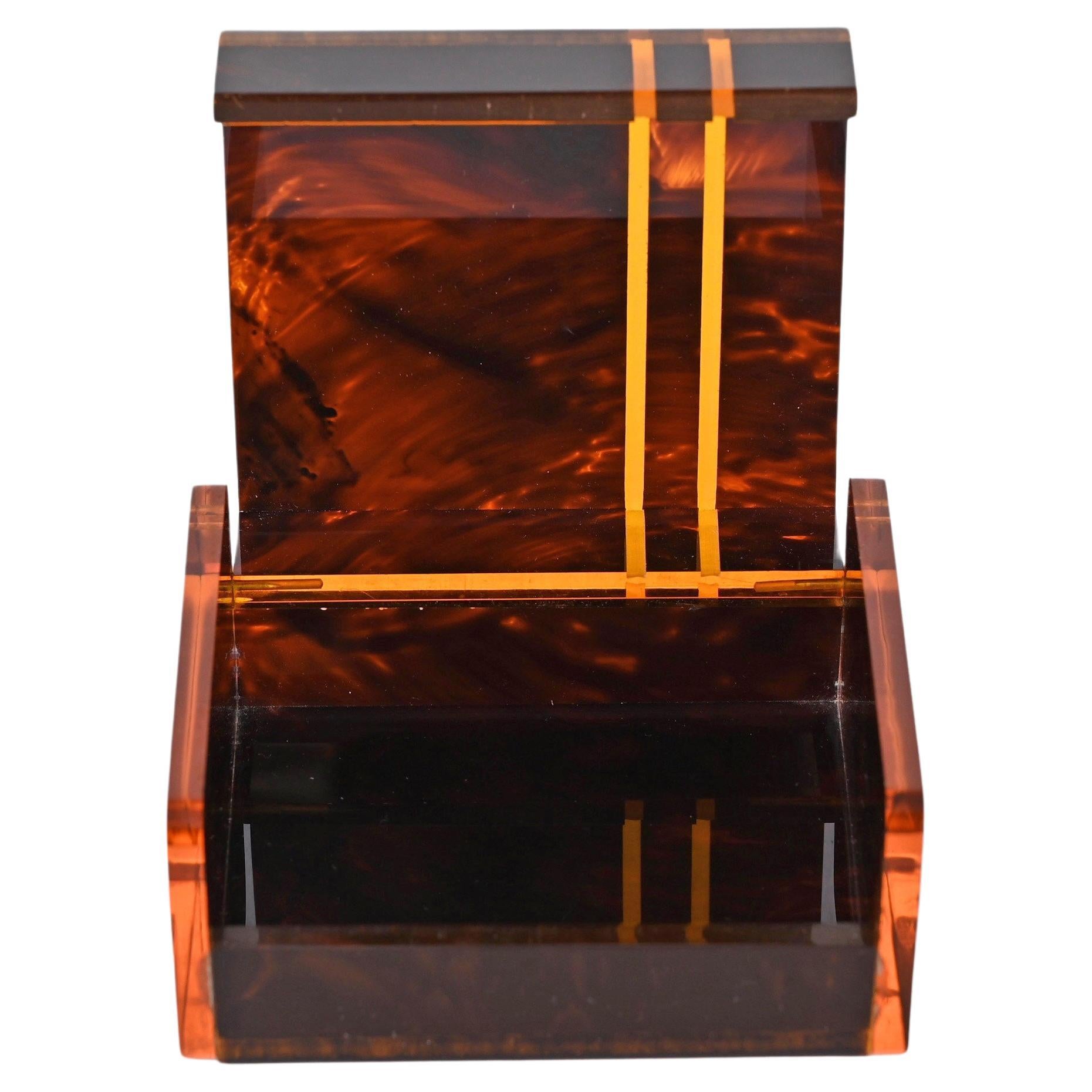 Wonderful midcentury lucite jewellery case, with marvellous tortoise effect. This astonishing piece was produced in France during the 1970s following Christian Dior style.

This item is timeless as the simplicity and elegance of its lines represent