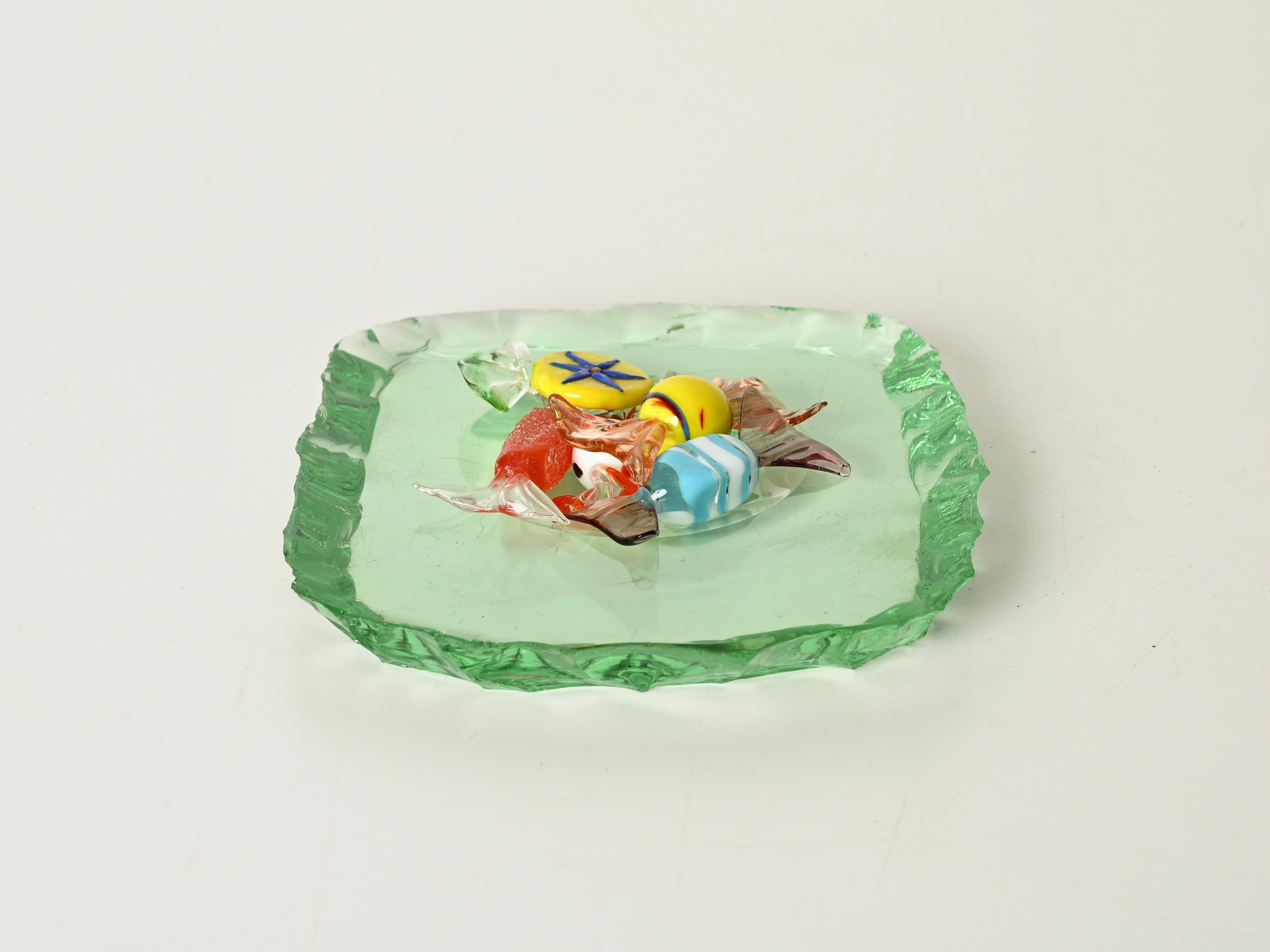 Wunderschöner Aschenbecher aus gehämmertem nilgrünem Kristall. Dieses bezaubernde Stück wird der Meisterschaft von Pietro Chiesa zugeschrieben und wurde in den 1950er Jahren in Italien hergestellt.  

Dieser quadratische Aschenbecher ist aus dickem