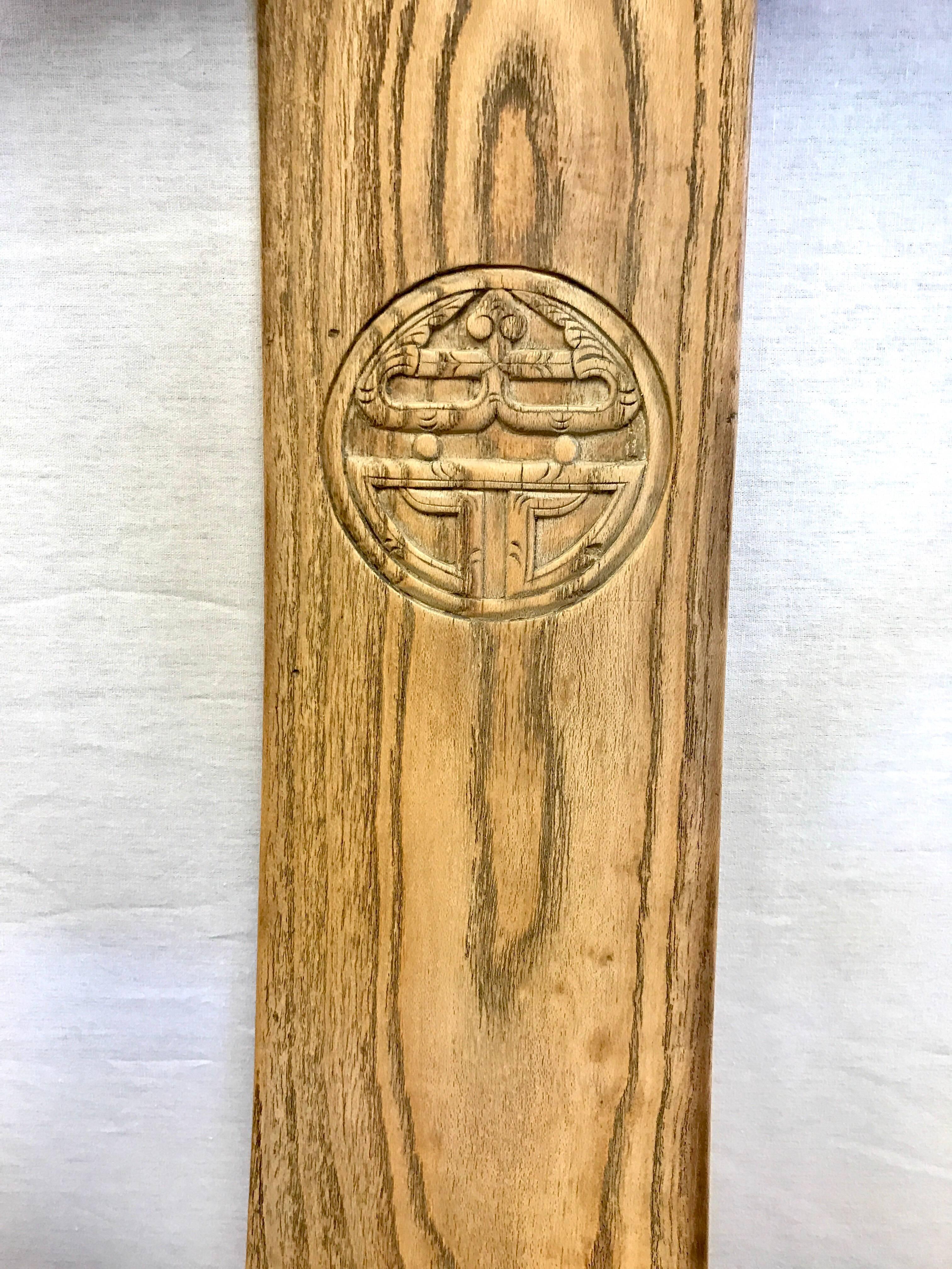 Pair of antique Chinese horseshoe chairs with caning on seats. The single panel back splat is decorated with a carved Chinese symbol.