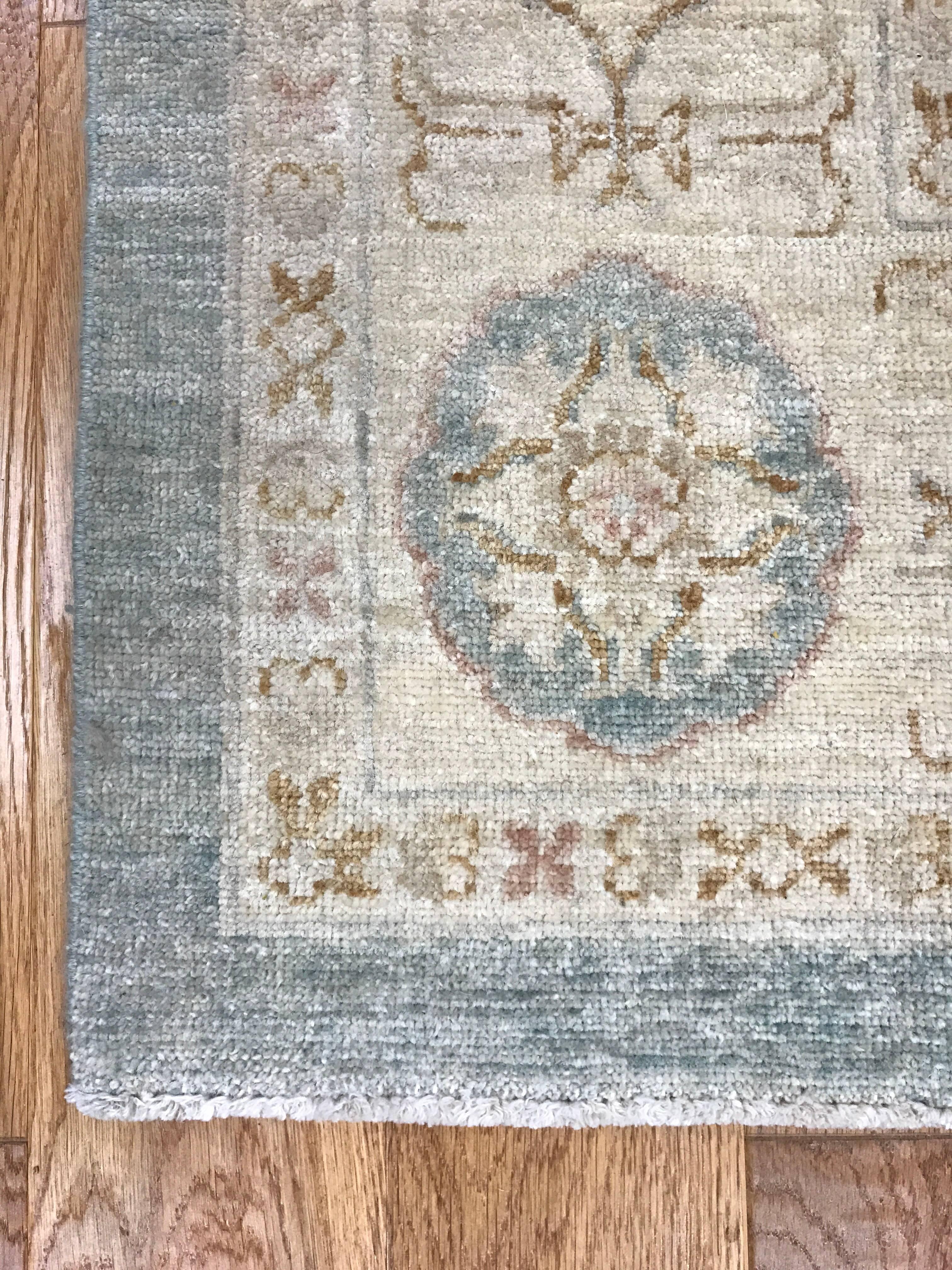 100% wood rug hand-knotted in Pakistan with muted tones of light blue and cream. In mint condition.
 