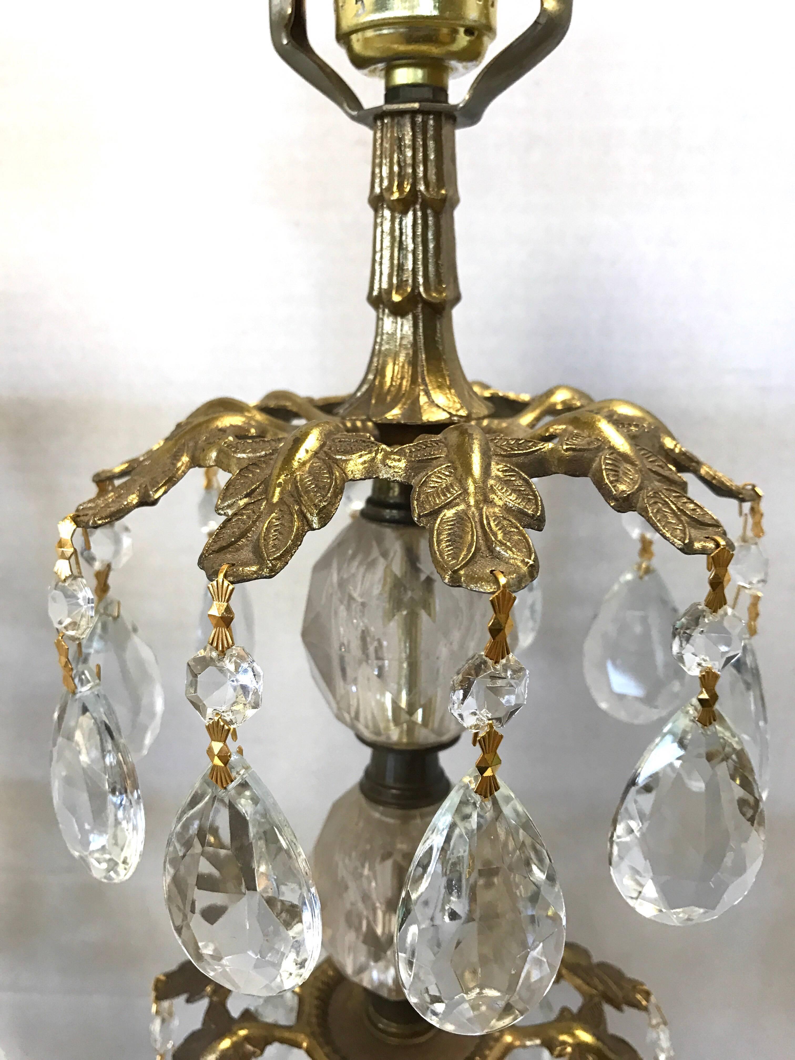 Pair of Hollywood Regency tall lamps with bronze and crystal mounted on marble bases.