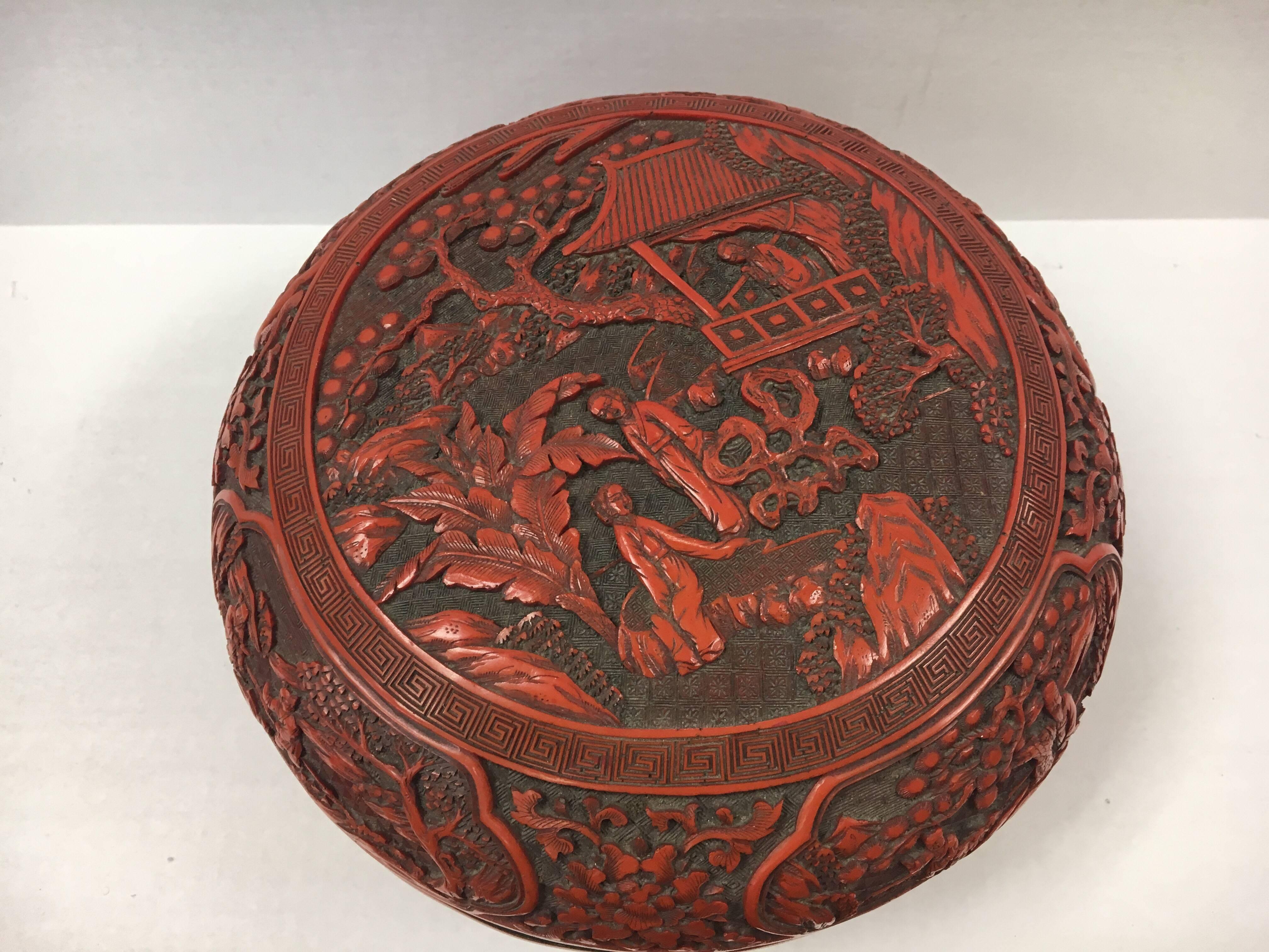 Rare cinnabar round lidded box with intricate carvings throughout. What makes this item most desirable is its size, which is much larger than the usual small trinket size cinnabar pieces available.