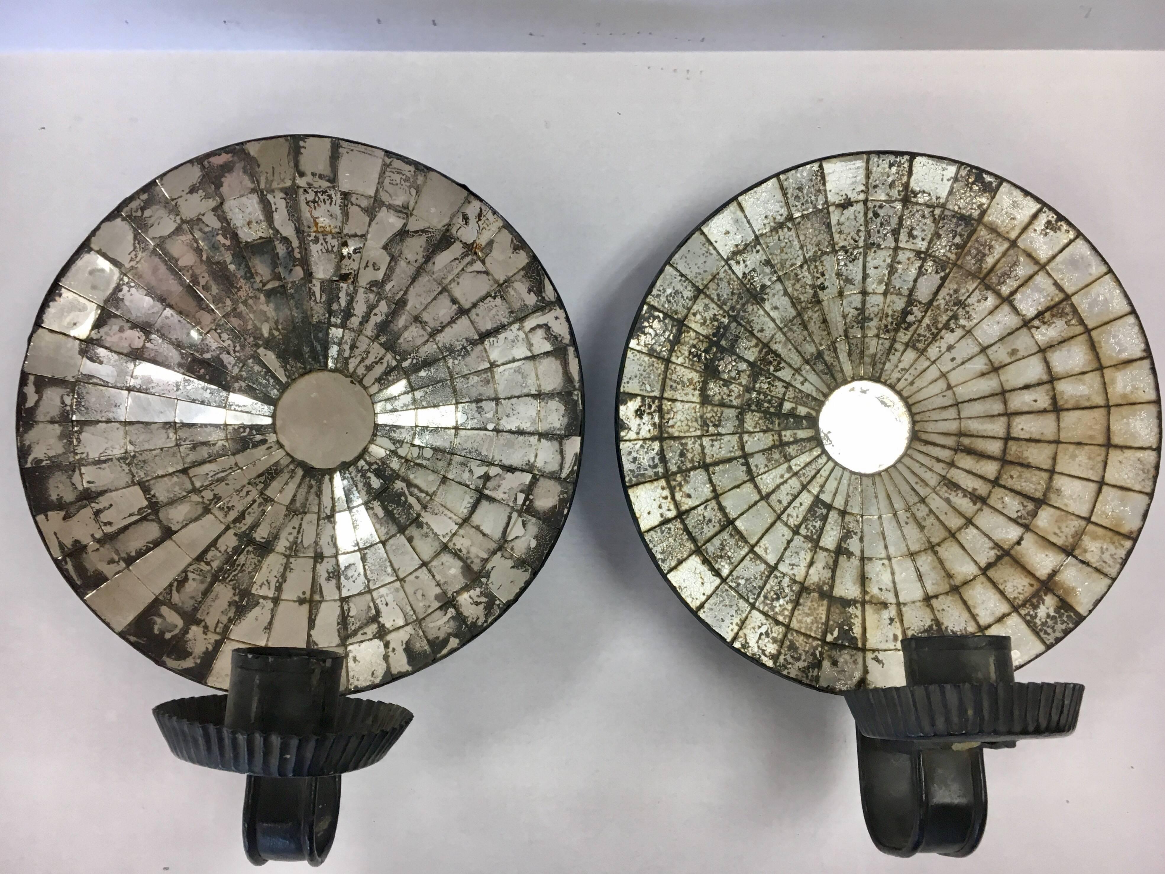 Coveted pair of American colonial tole and mirrored candle holders from the late part of the 19th century.
All original. A pair of painted tin candle sconces with mirrored reflectors, from the late 18th century. Having a round convex form in