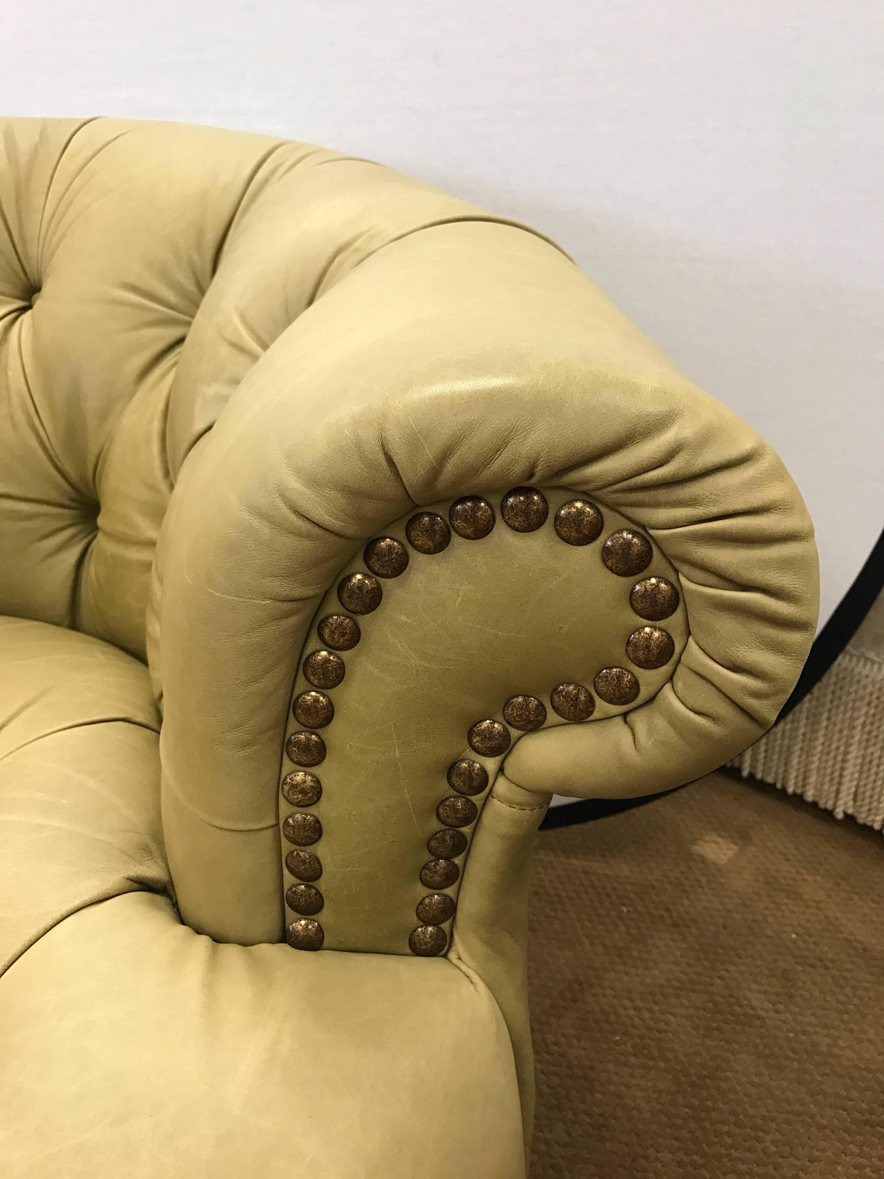 Pair of leather Chesterfield chairs with nailhead trim. Made in Italy. Features unusual pale olive leather color scheme.