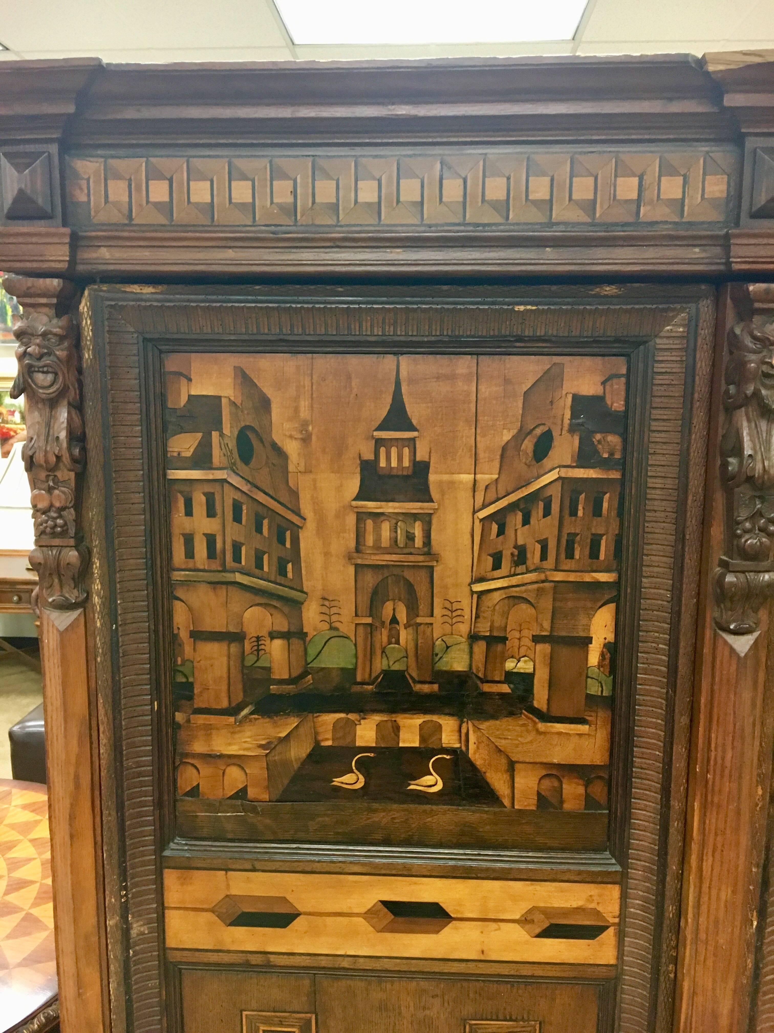 Antique 18th century Austrian armoire that features intricate marquetry inlay with an architectural theme. Unique carvings on frame and feet. Put together with pegs, no tools needed. Easily assembled and disassembled. Comes with lock and key. All