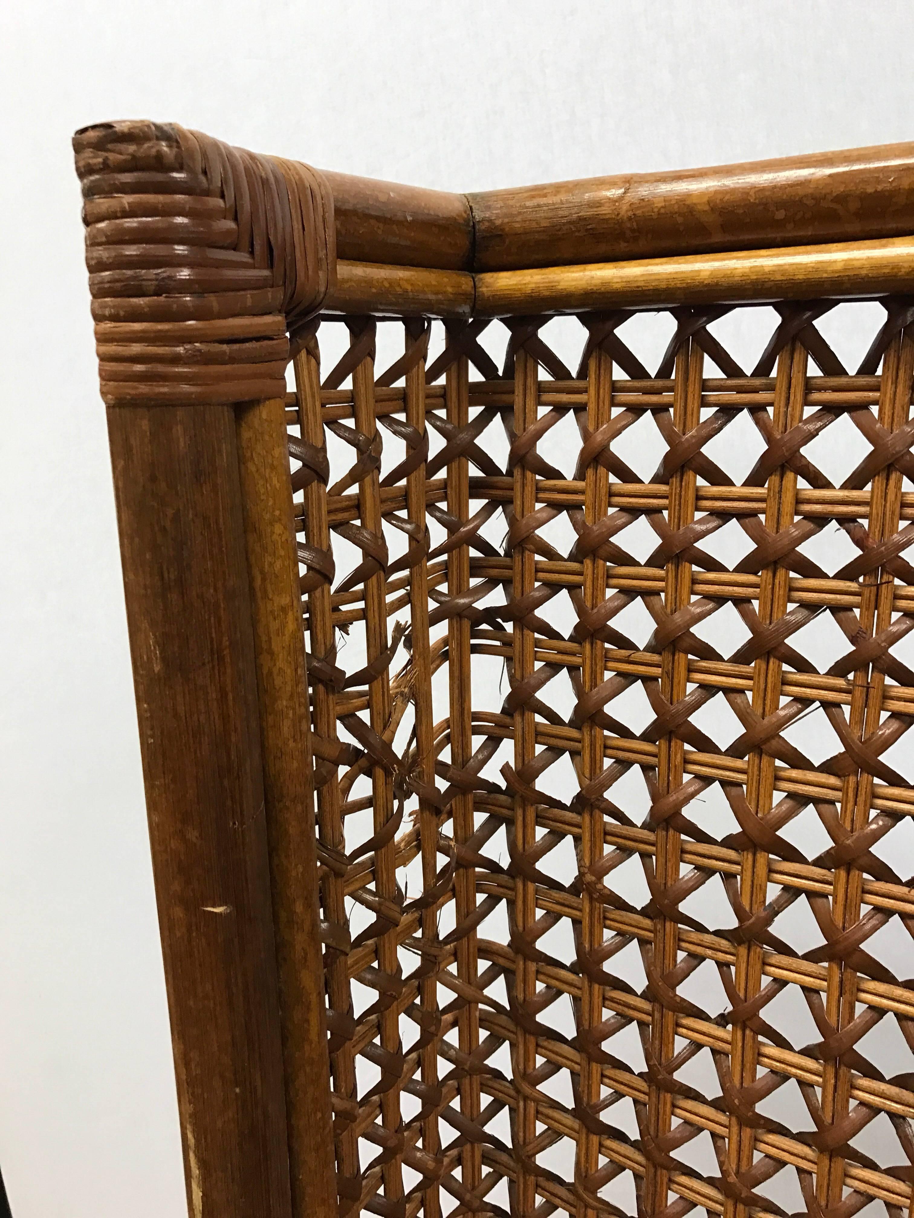 Very tall Danish midcentury wingback rattan chair with a woven back and woven wicker seat.