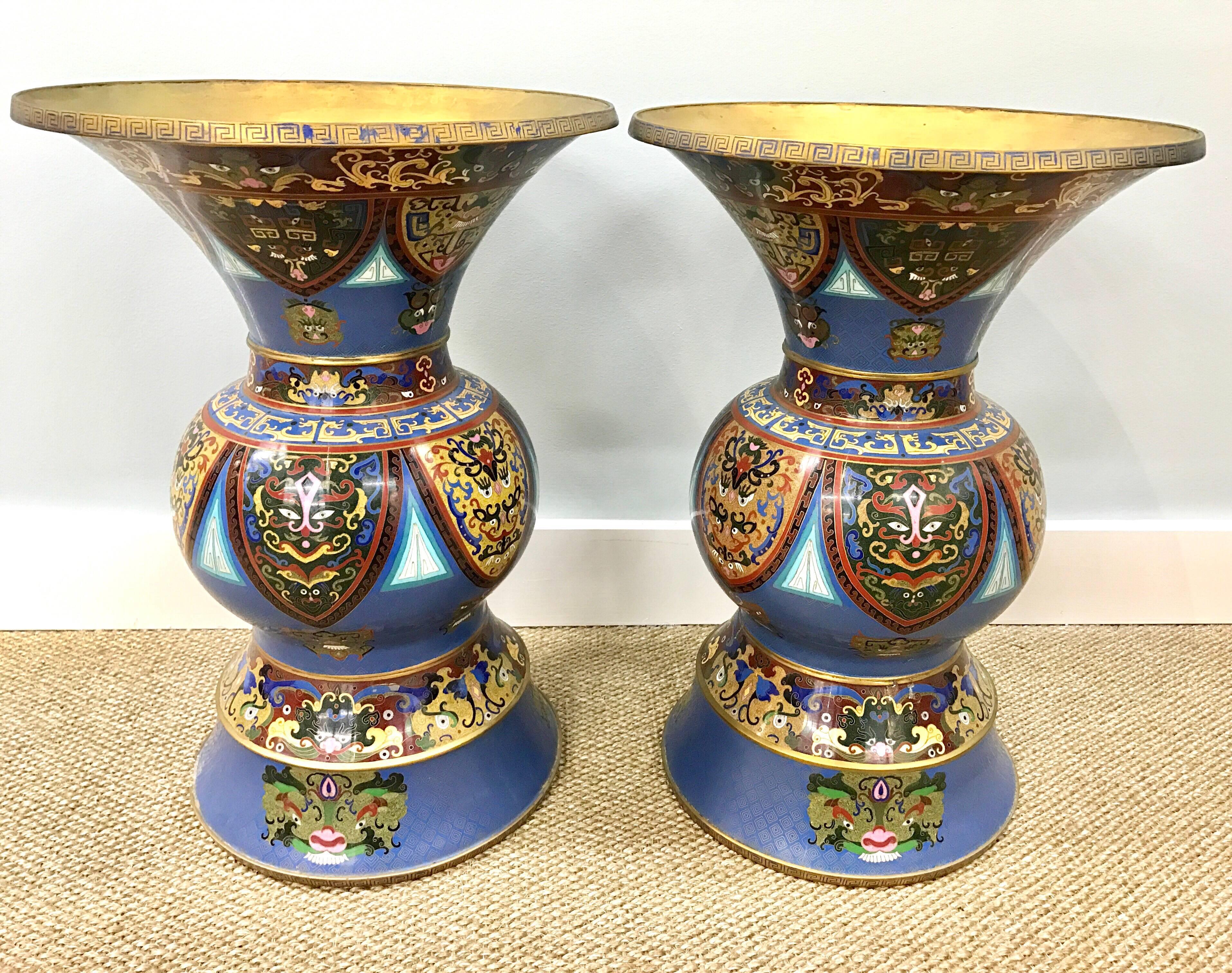 Unusually shaped pair of matching cloisonné enameled Chinese urns or vases decorated with animal and dragon faces. The scale is large.