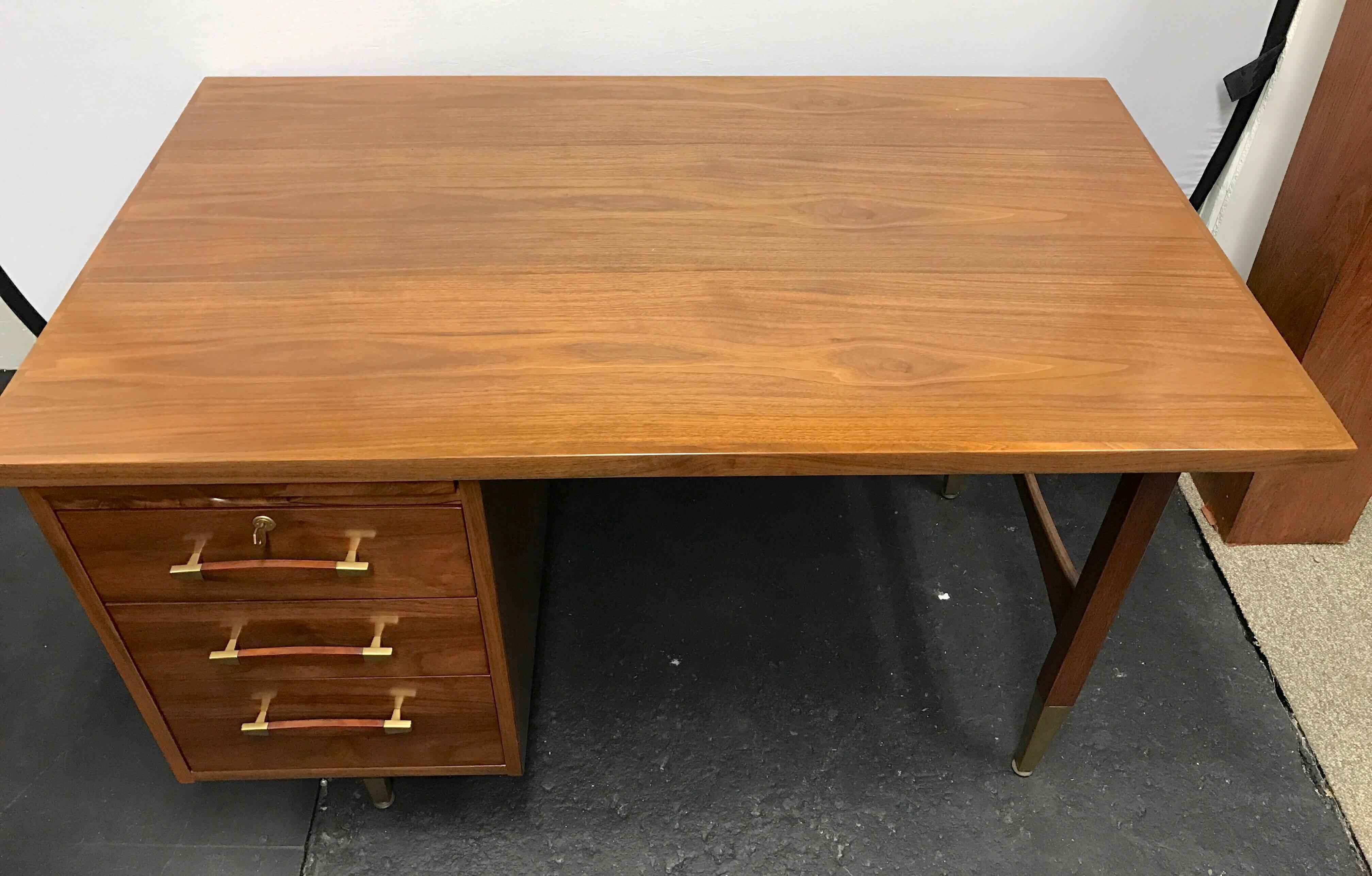 Sleek Danish Mid-Century Modern desk with oiled walnut wood. All original and comes with lock to secure your valuables.