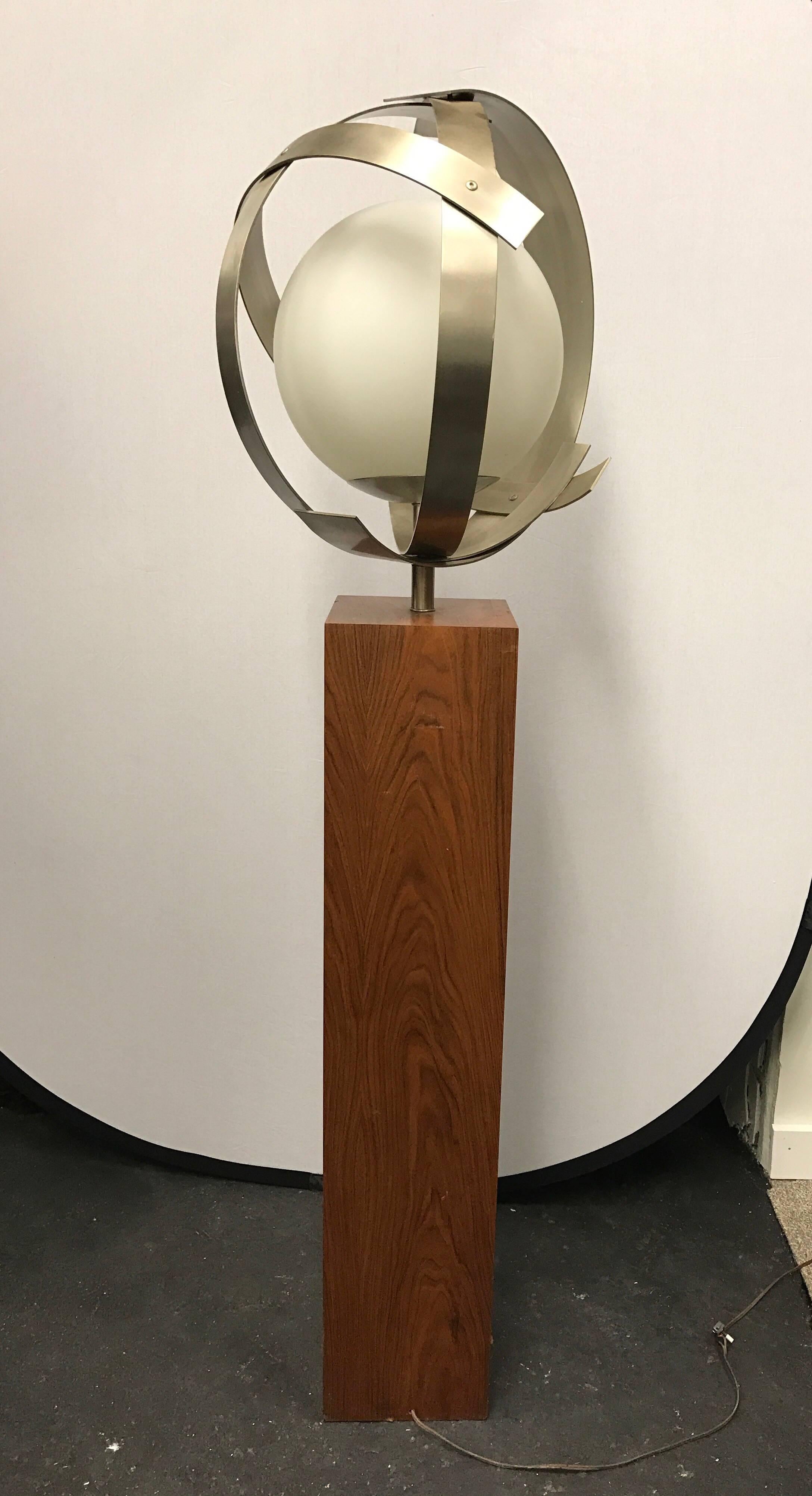 Midcentury globe lamp inside a silver metal sculpture and mounted on a wood base. Made in Italy.