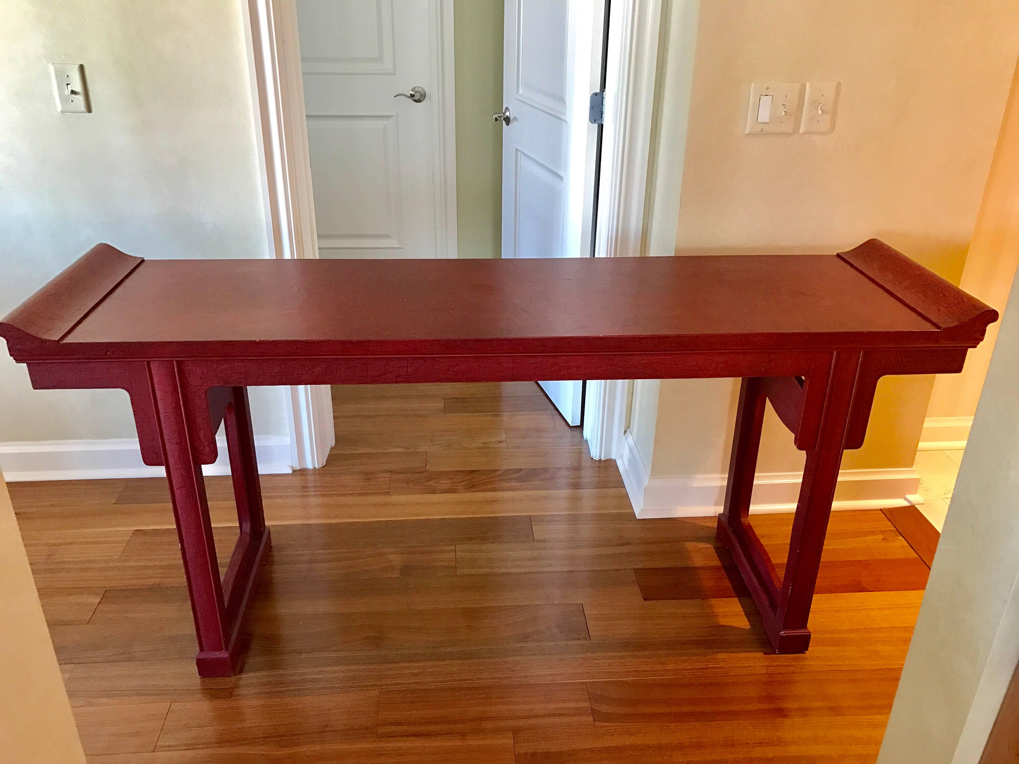 Elegant signed Baker Furniture large console/altar table finish with a crackled red cinnabar color. 
Baker gold medallion is attached to bottom.