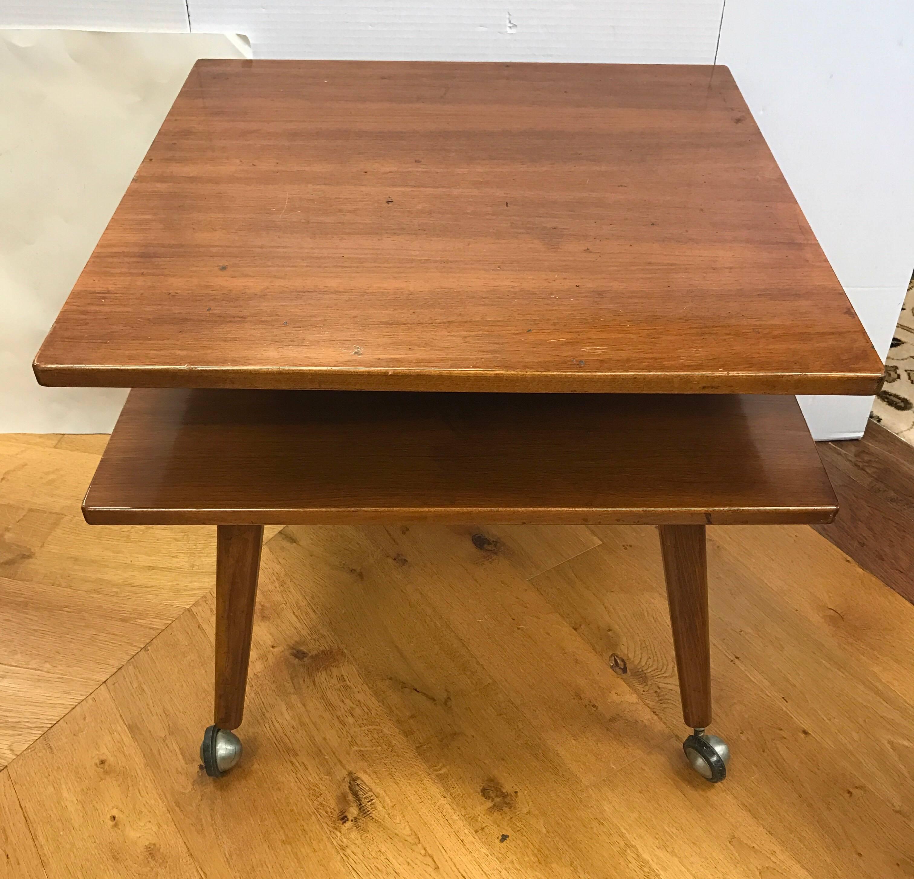 Swedish DUX midcentury two-tier table done in teak and features caster for feet for ease of movement.
DUX's made in Sweden logo incised at bottom.