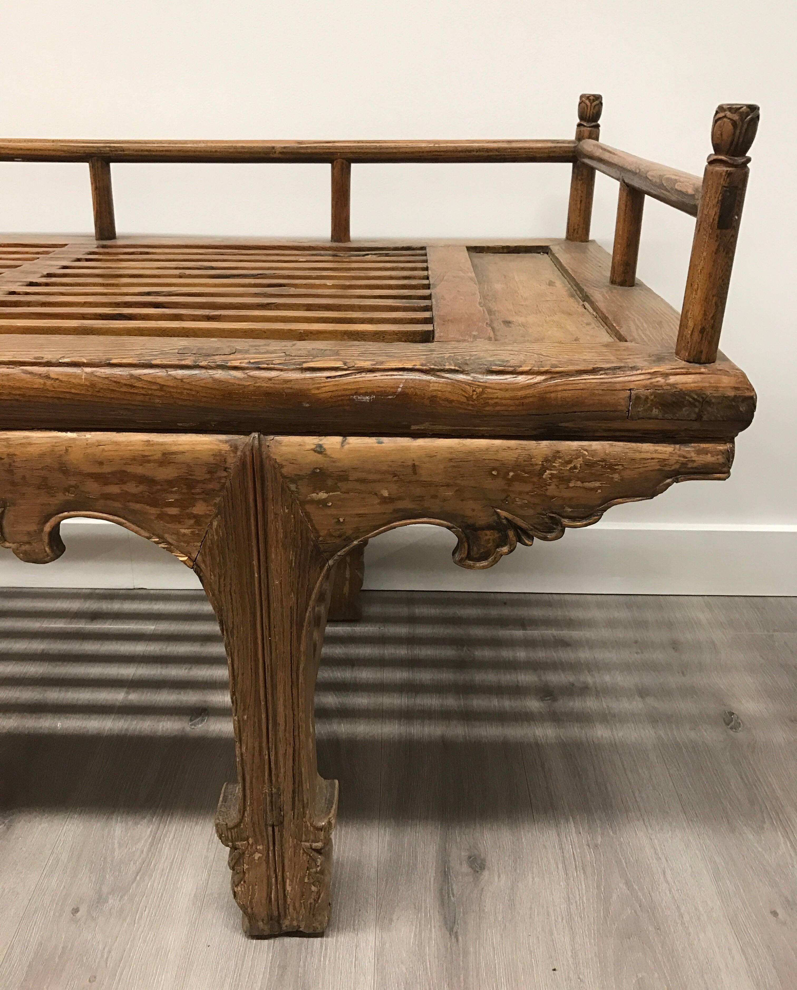 19th century Chinese slatted daybed with scalloped and carved apron and feet.