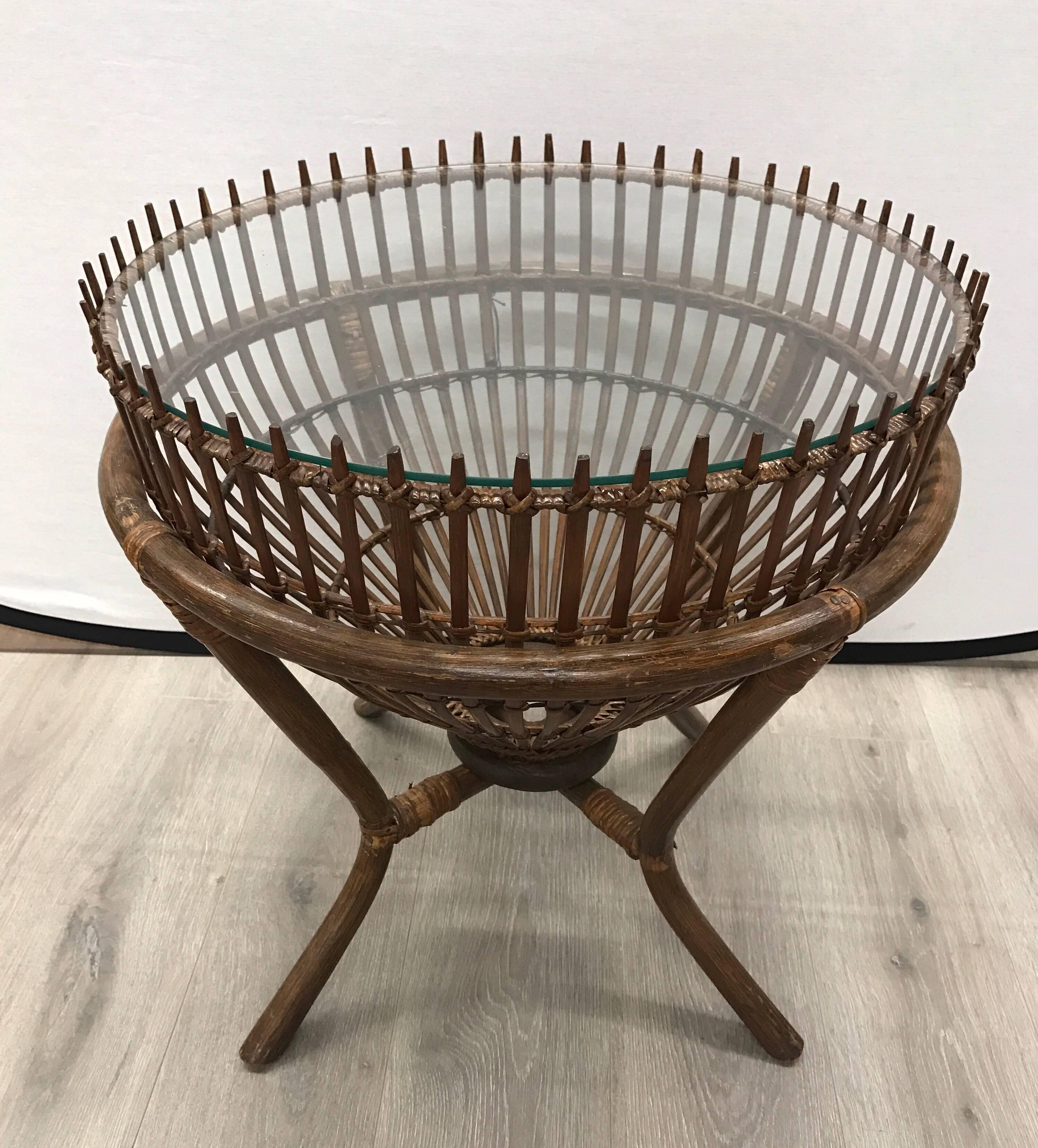 Pair of vintage Franco Albini style round fish trap side tables with glass tops. Handcrafted from bamboo and rattan with a glass top.
 