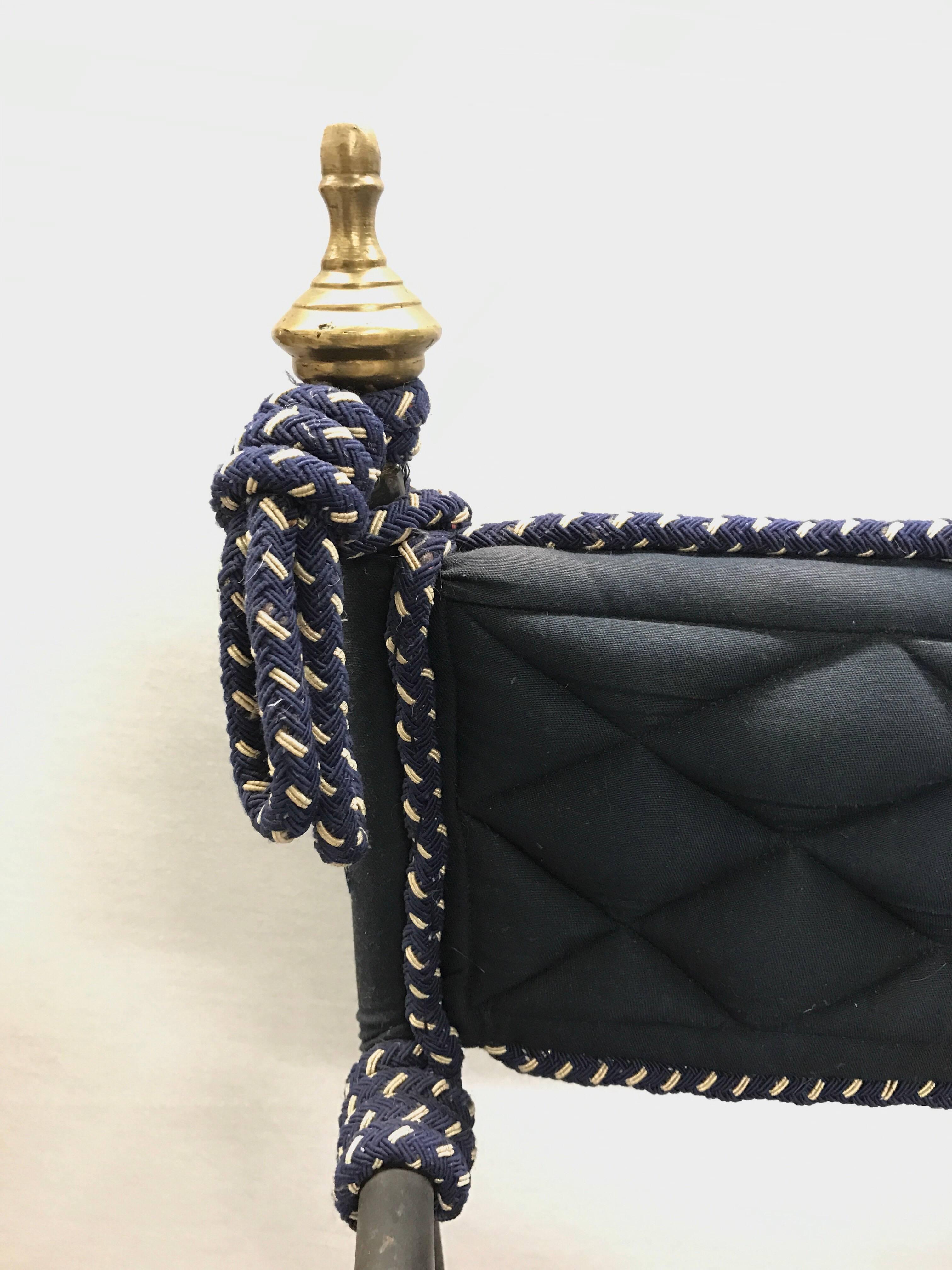 Italian Savonarola Campaign style folding chairs with wrought iron and brass finials. Rich navy upholstery with blue and white cording. Loose quilted cushion on seat.