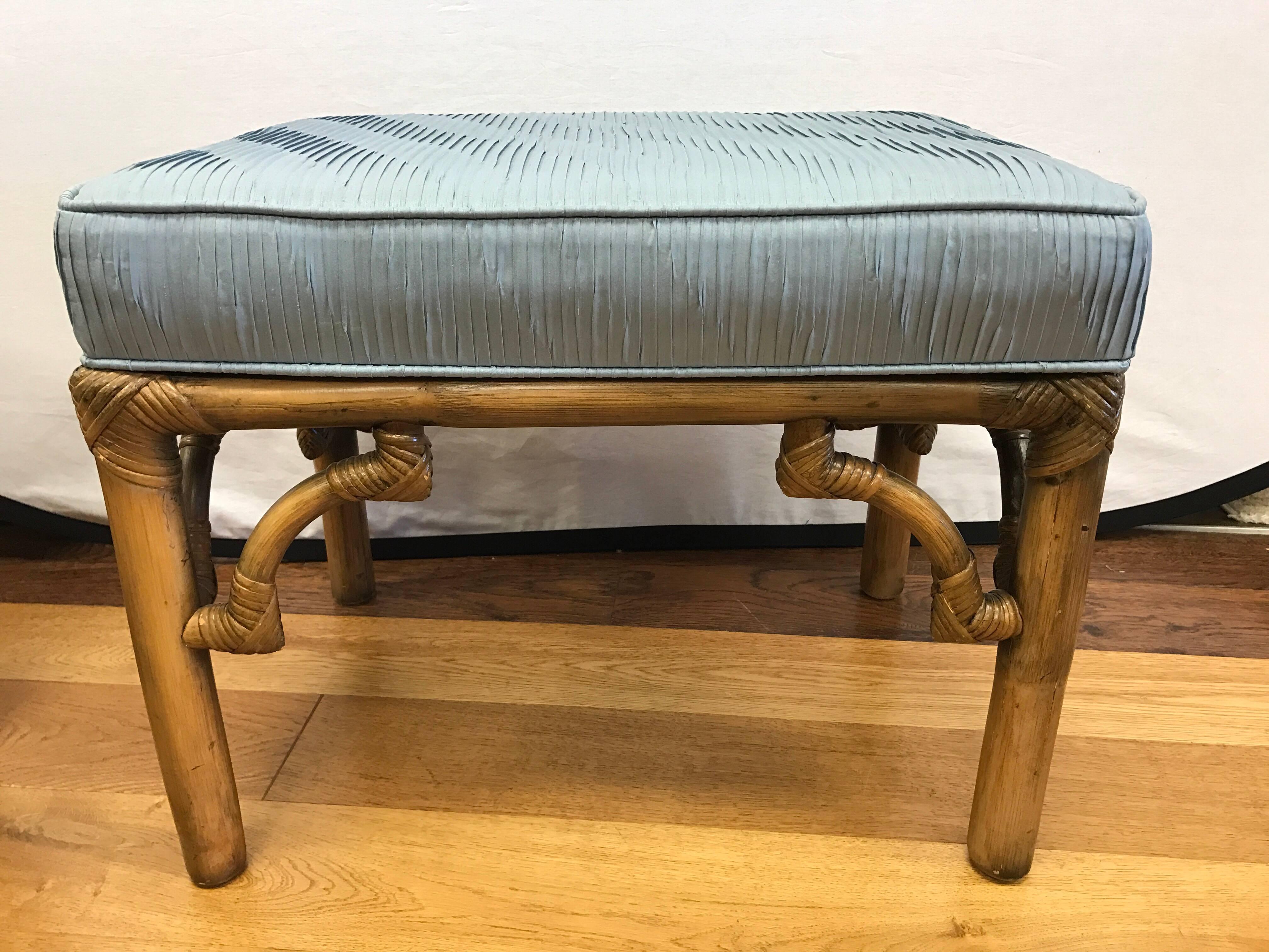 Pair of midcentury bamboo benches upholstered in a light blue, pleated silk fabric.