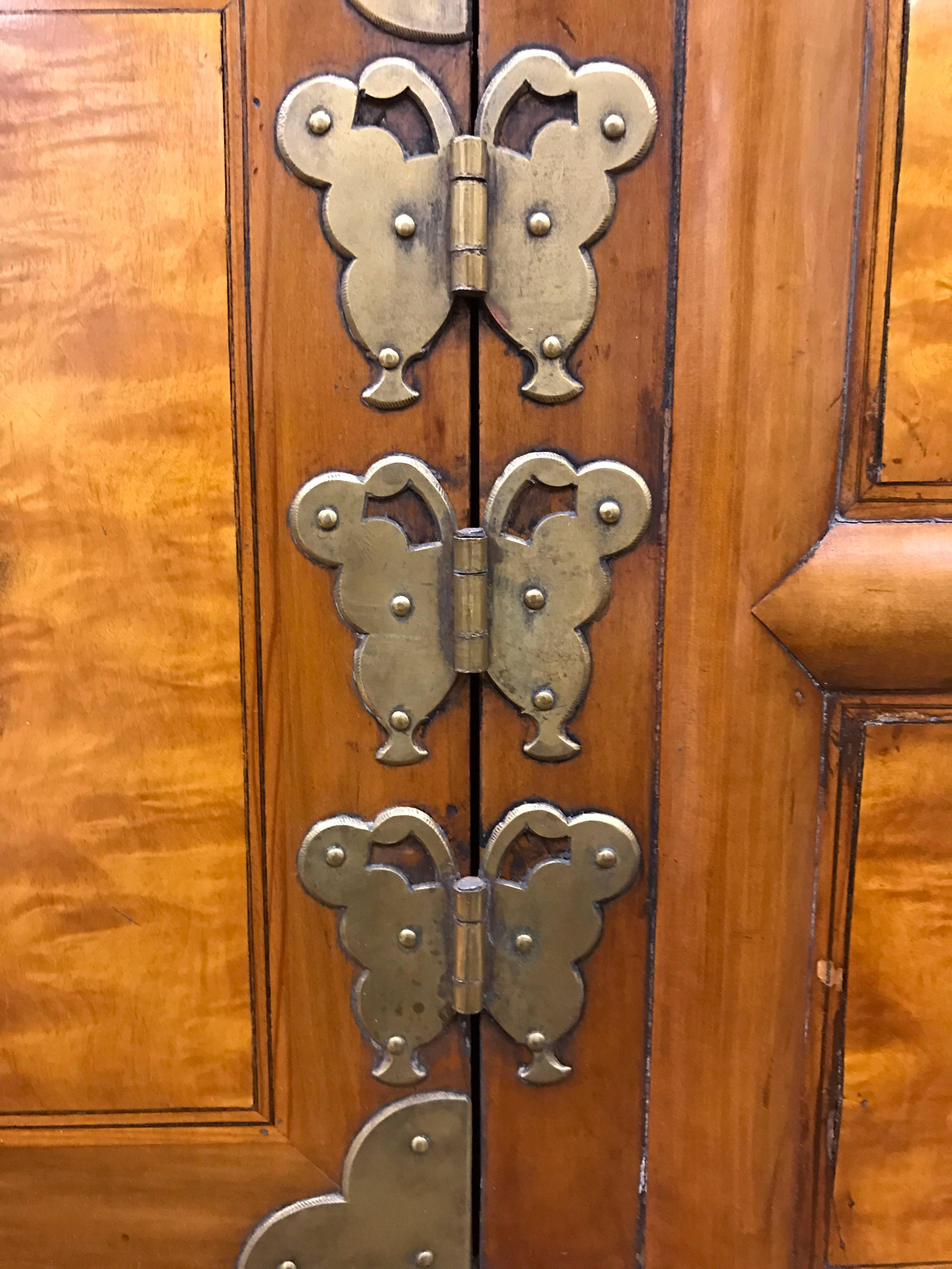 Antique Korean tansu or chest with COA with two locking doors.  Made of maple wood with persimmon inlay and hand-beaten yellow brass fittings. Piece dates back to the Yi Dynasty from the 1840's - 1875. The chest was acquired from the Kyung Ki Do