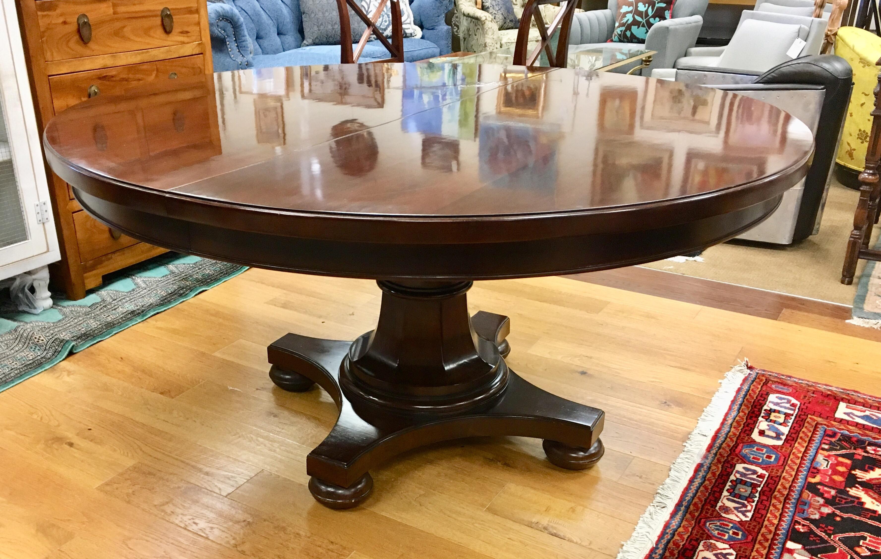 Heavy Bernhardt round mahogany pedestal dining room table, circa early 21st Century. The round table is 5 feet in diameter and expands to 7 feet with 24 inch leaf and becomes oval in shape.