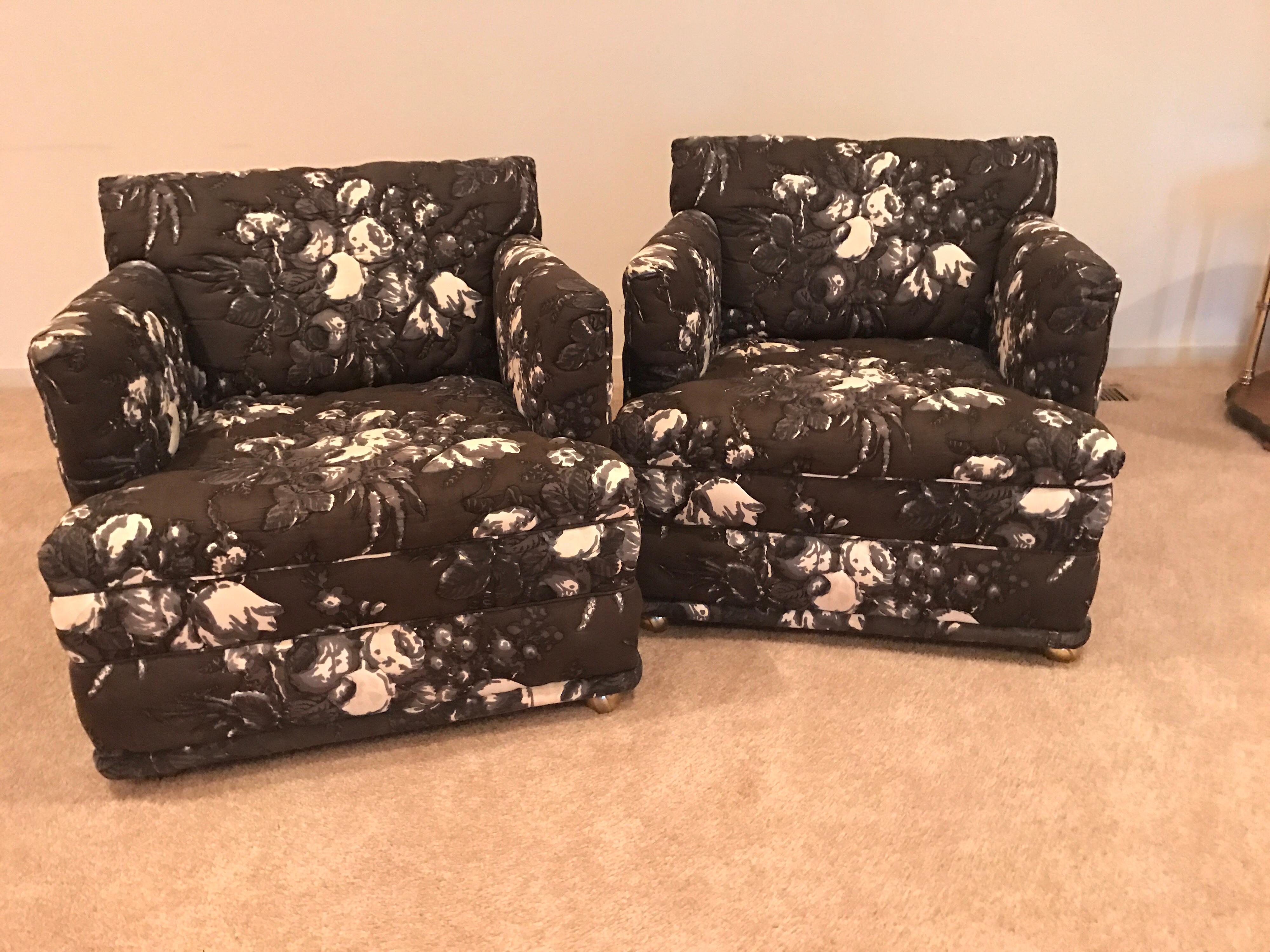 Pair of matching upholstered lounge chairs on casters from the 1970s. Black and white quilted floral upholstery is original and in excellent condition.
