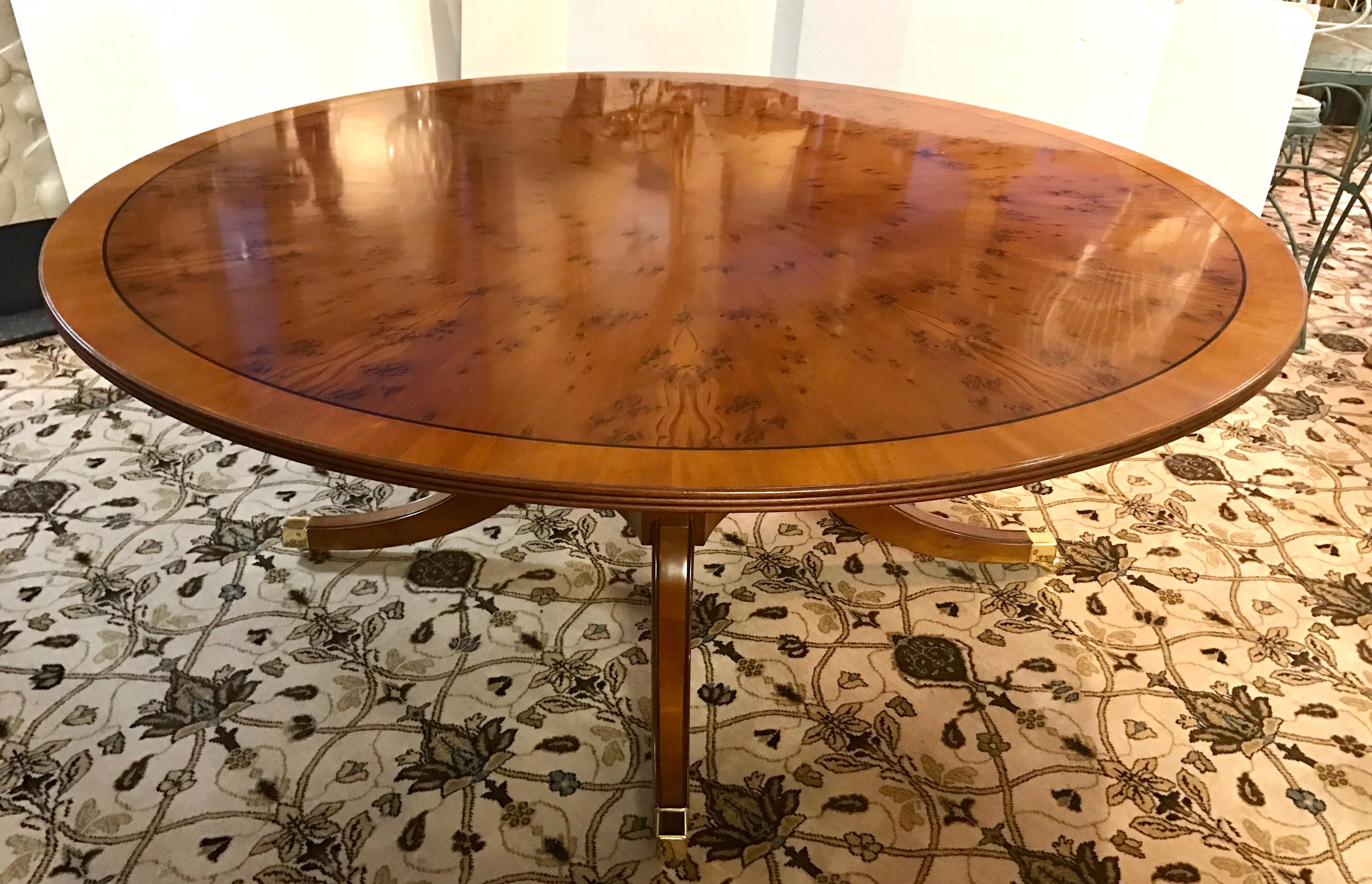 Stunning round yew wood dining table that is marked made in England. Fabulous condition, no leaves, sits up to 10 depending on chairs.