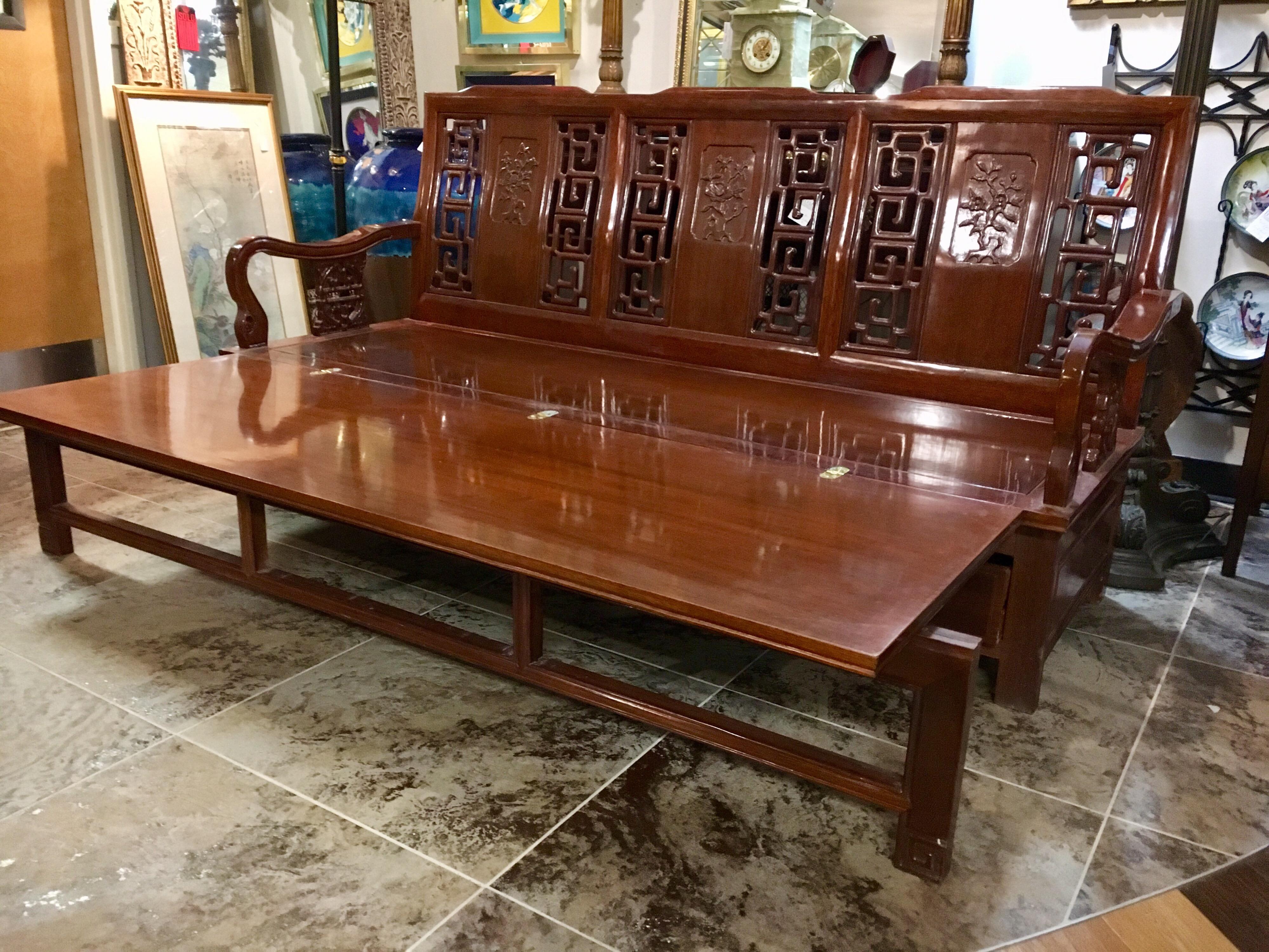 Magnificent Asian 20th century wooden settee that expands into a daybed. It features instant expandability as well as three drawers at bottom for storage. When piece expands, its depth goes from twenty-six inches to fifty inches. All other