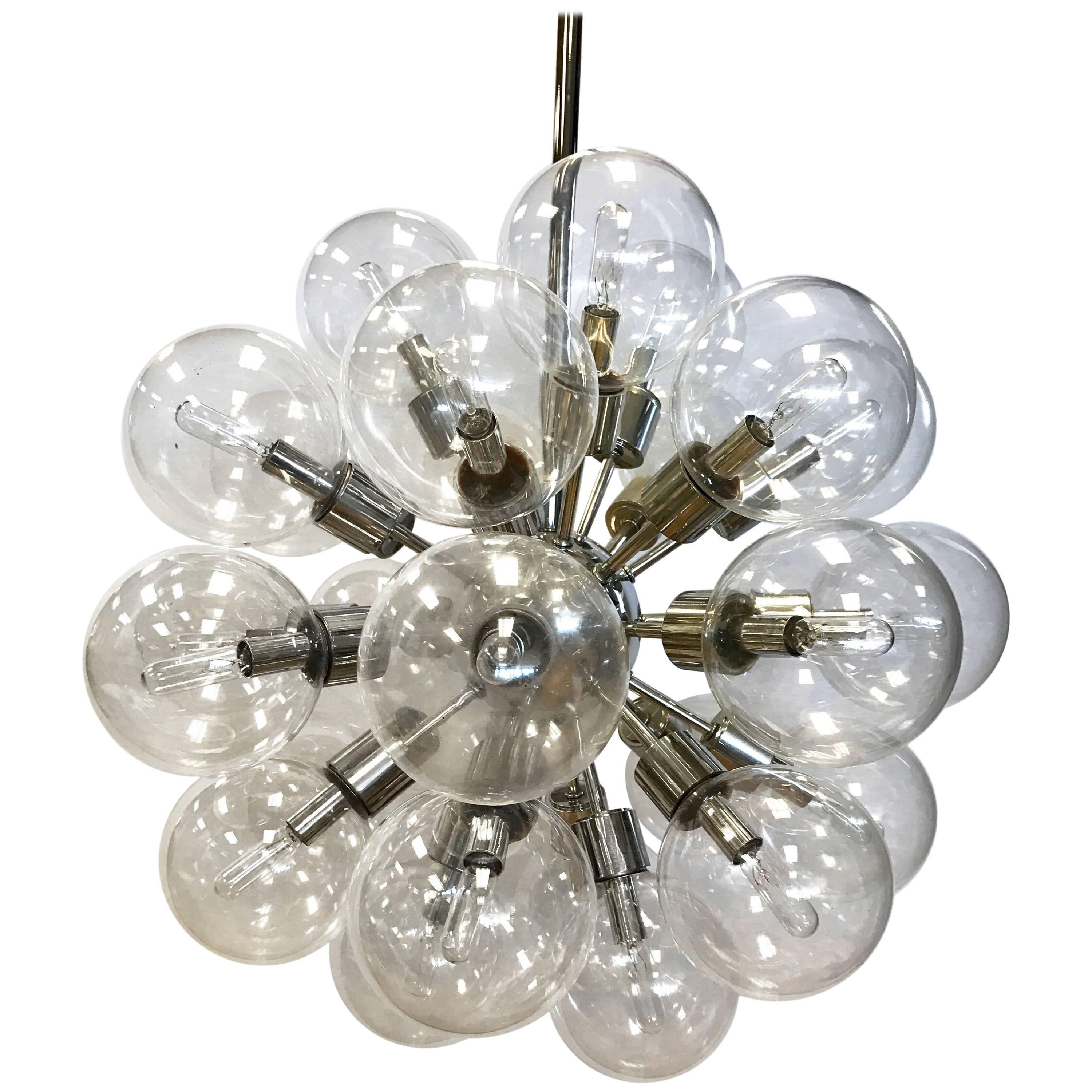 Rare, matching set of eight coveted Mid-Century Modern Lightolier 30 light Sputnik chandeliers, circa 1960s. Features 30 original glass globes on polished chrome spokes radiating from a central chrome nucleus. They are made of polished chrome and
