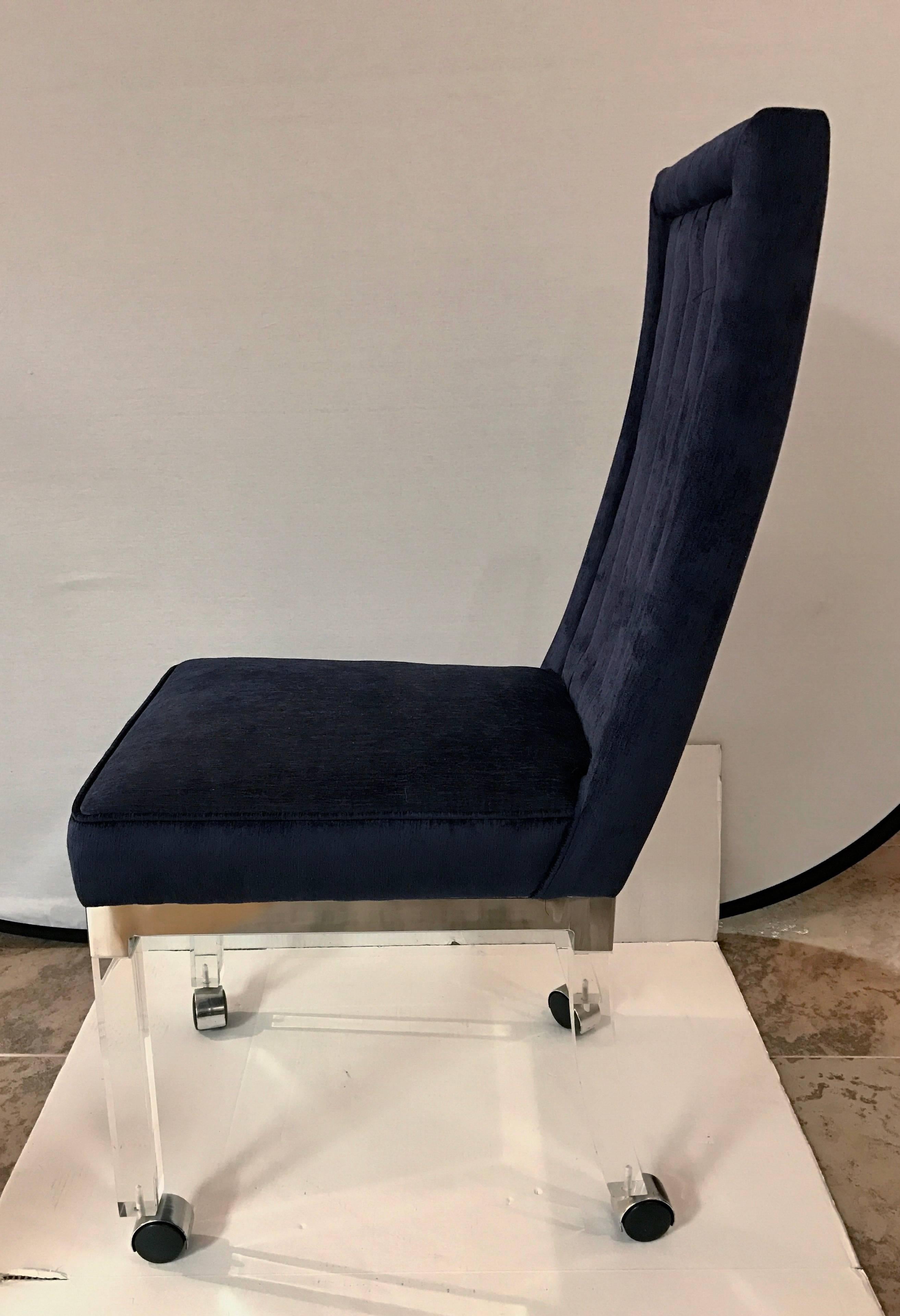 Stunning Charles Hollis Jones Mid-Century Modern Lucite dining chair on removable castors. Features four Lucite legs trimmed with chrome, and channel back tufting in a deep royal blue velvet-like fabric.
  