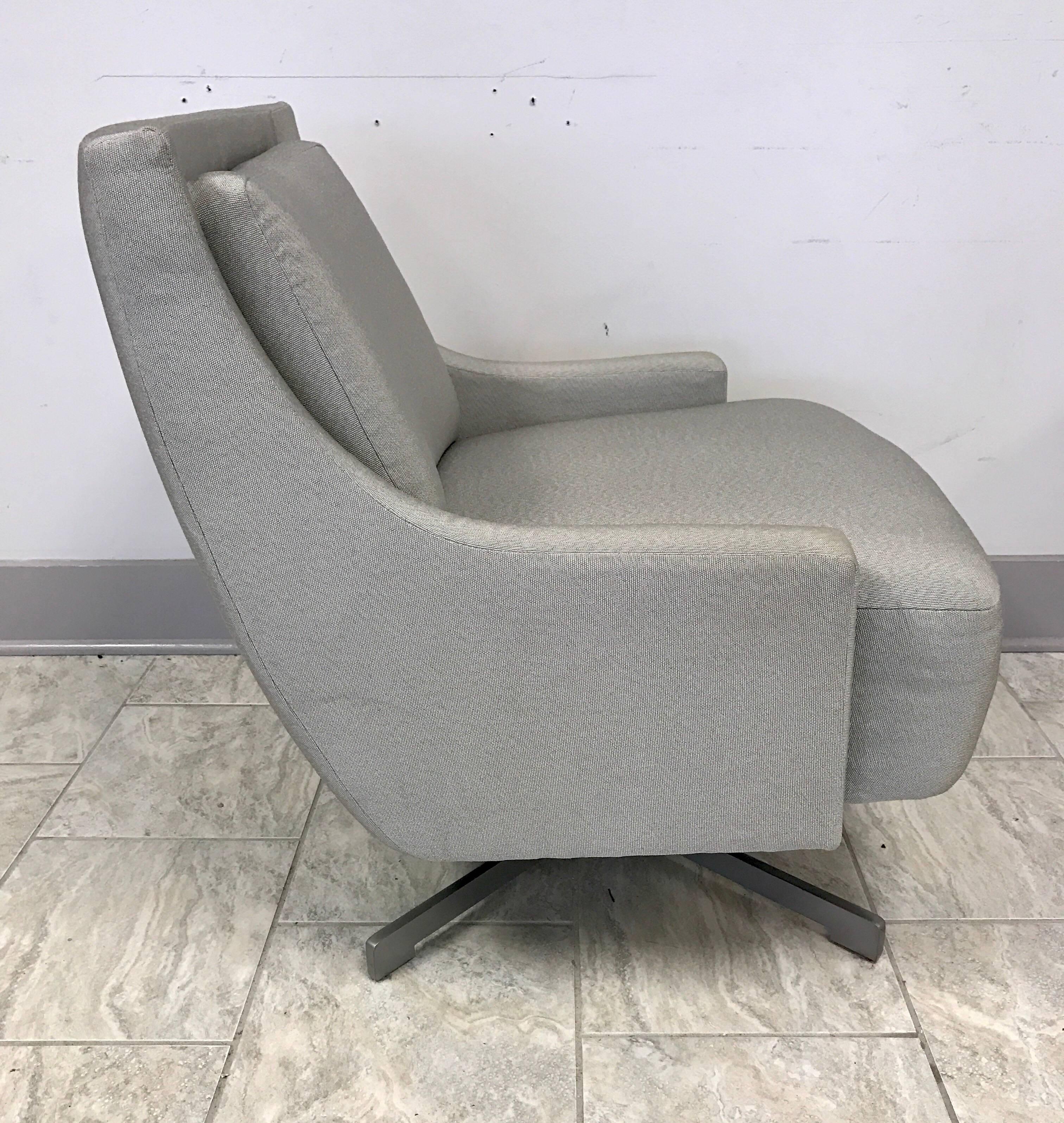 Sleek yet comfortable Barbara Barry designed HBF swivel chair on a four prong self-centre steel base done in a luxurious gray fabric.