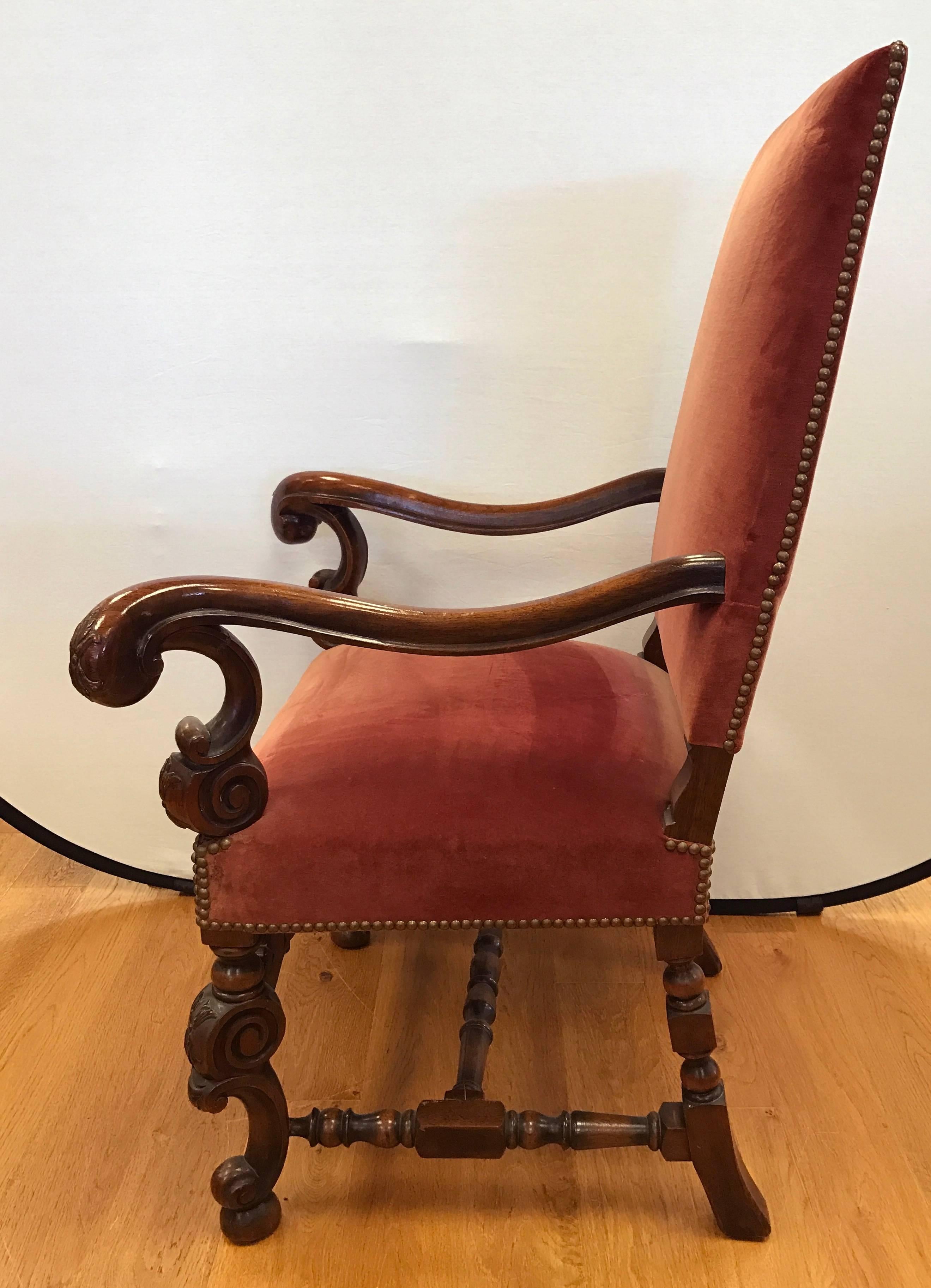 Pair of Italian carved walnut arm chairs with rust colored velvet upholstery.