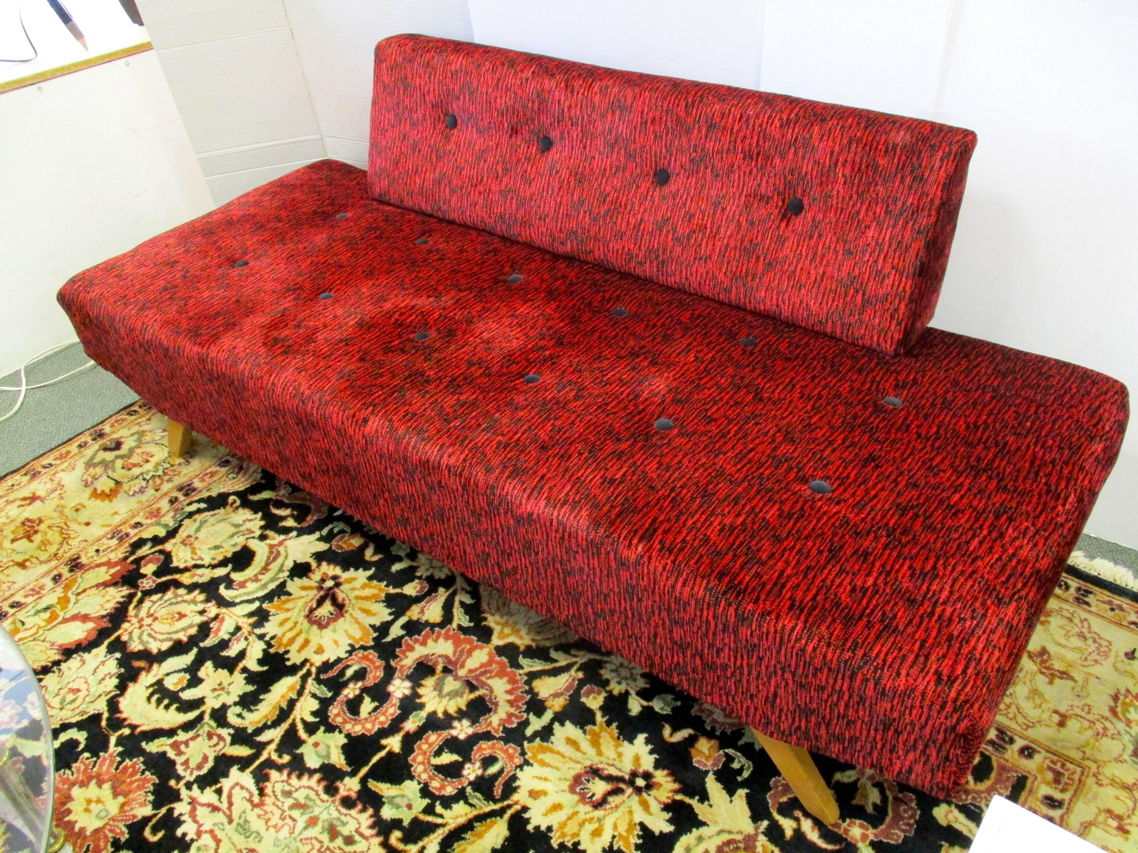 Two midcentury daybeds newly upholstered in a red with black chenille fabric. Back cushions is removable and turns into a bed.