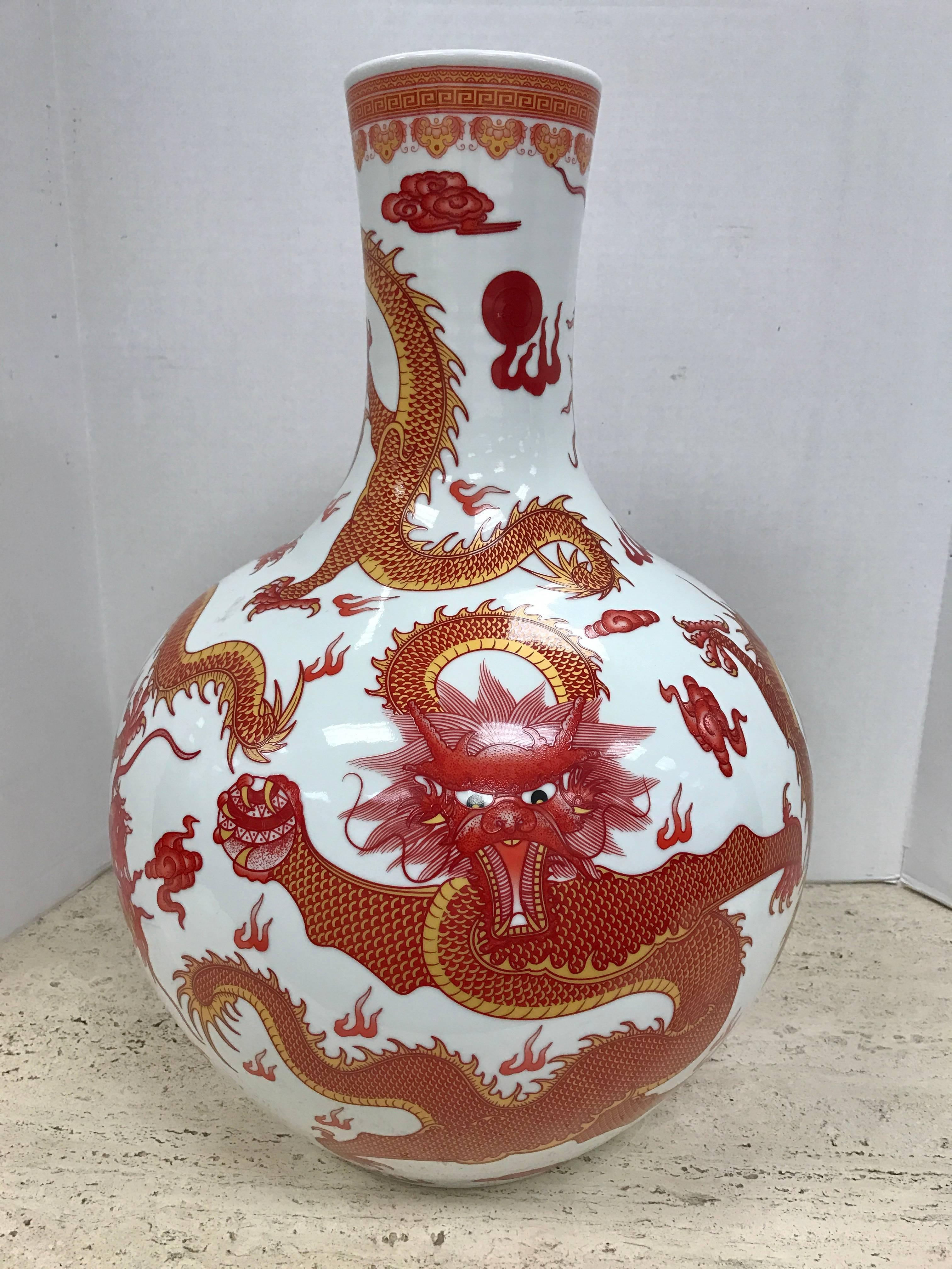 Large Chinese orange and white vase painted beautifully detailed dragons all around.