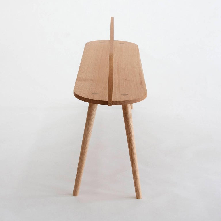 The Bench Bucket Stool is the longest of four versions from the Bucket Stool Collection, a family of solid ash furniture featuring bentwood handles. The Bucket Bench is a versatile piece, excellent as a dining bench, entryway seat, coffee table,