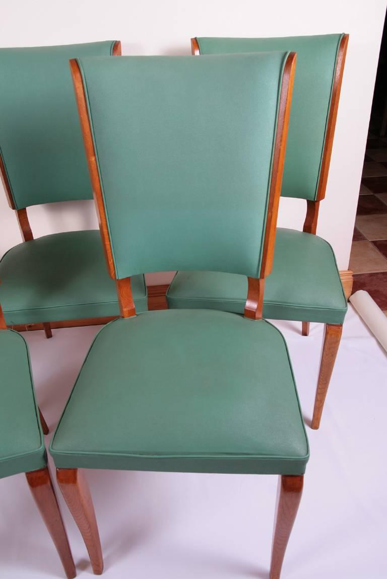 Fabulous set of five French Art Deco dining chairs in blond oak with the original faux leather upholstery in the style of Jules Leleu. We believe that these chairs are in original condition.