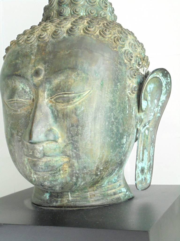 Mid 20th century bronze  Kandy (Sri Lankan) style, Buddha head on a wooden base.