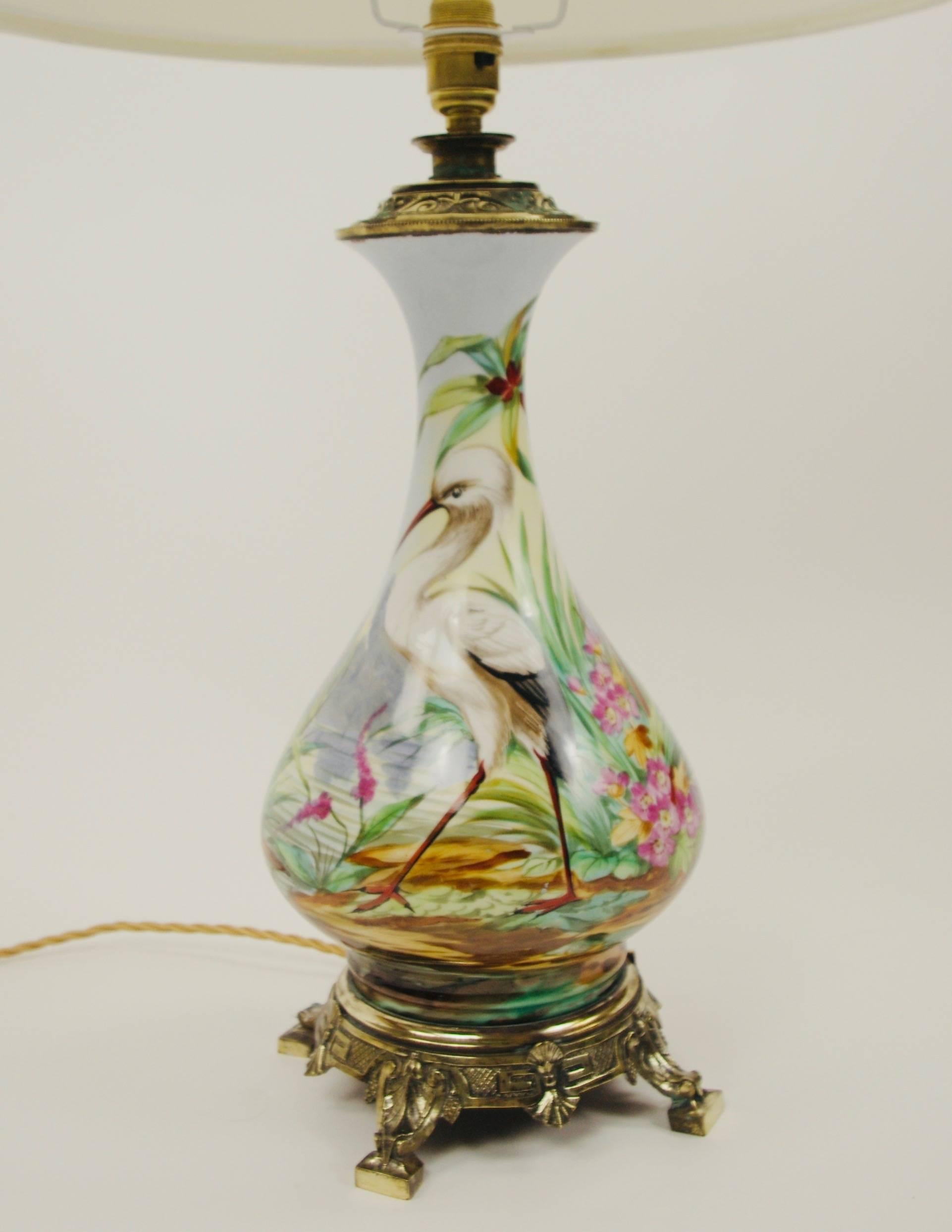 19th Century porcelain oil lamp depicting a heron and verdant foliage, now electrified  for modern usage. Original base and vase cap. Lampshade included

Wired UK and Pat tested.
This item is on show in Berkshire UK