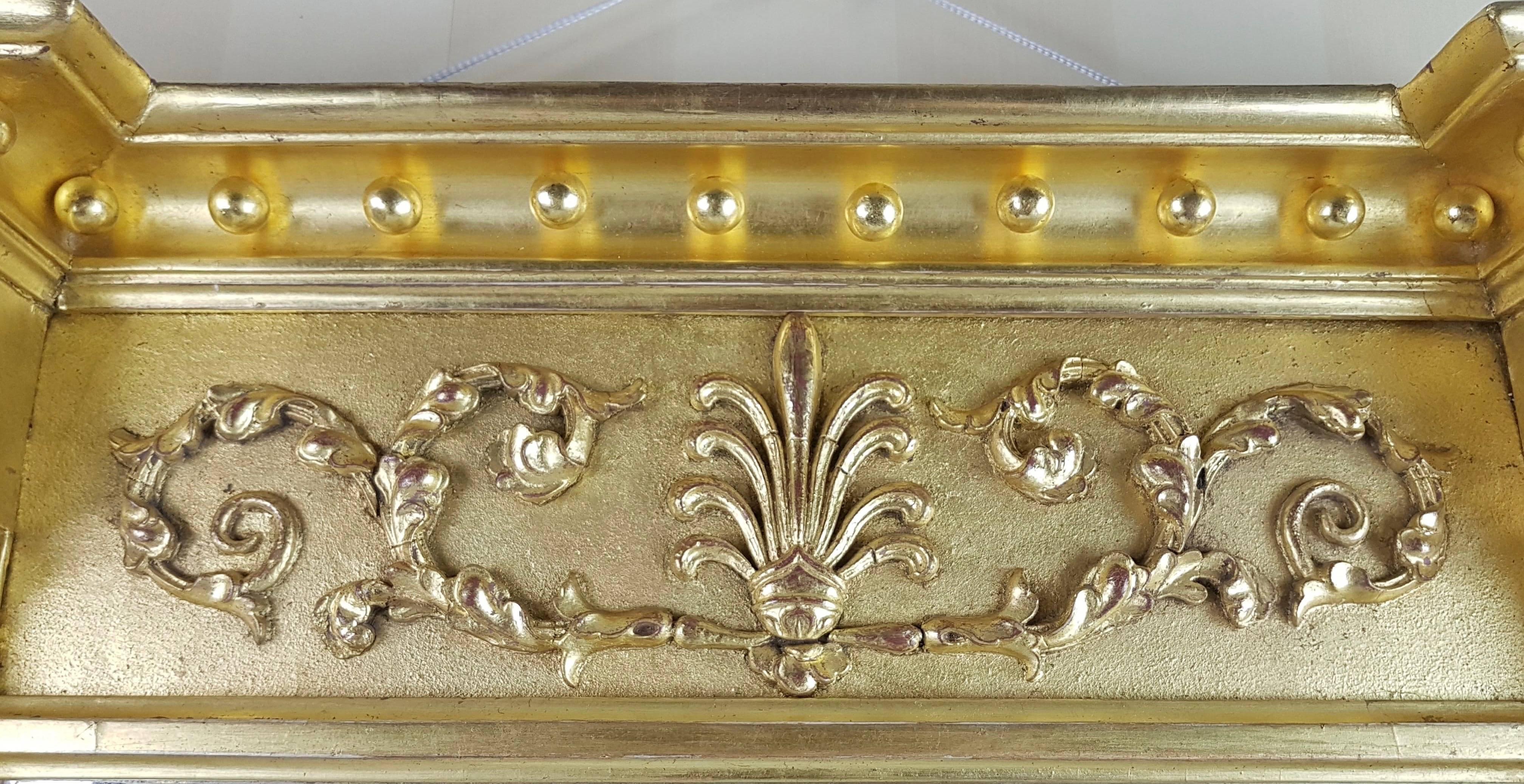 Regency pier glass mirror with raised and decorated pilasters and frieze with raised foliage decoration on a matte ground with burnished highlights. Water gilded in 22-carat English gold leaf. 

This item is on display in Berkshire - UK.