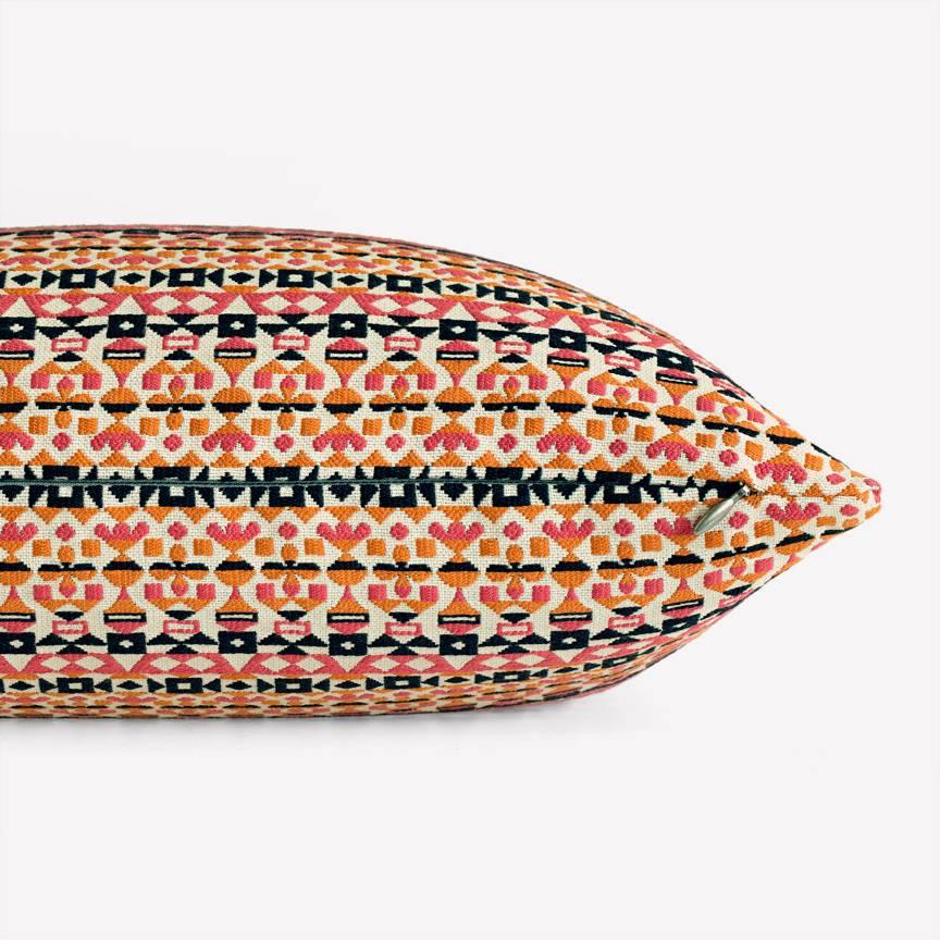 Maharam Pillow
Arabesque by Alexander Girard 
002 Pink and Orange

Arabesque, designed by Alexander Girard in 1954, is a graphic pattern composed of ribbons of small glyphic, geometric motifs in bold colors with metallic details. A dense satin weave