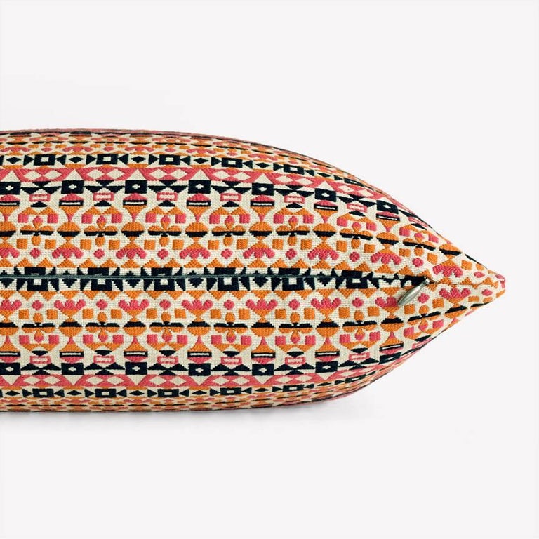 Maharam Pillow
Arabesque by Alexander Girard 
002 Pink and Orange

Arabesque, designed by Alexander Girard in 1954, is a graphic pattern composed of ribbons of small glyphic, geometric motifs in bold colors with metallic details. A dense satin weave