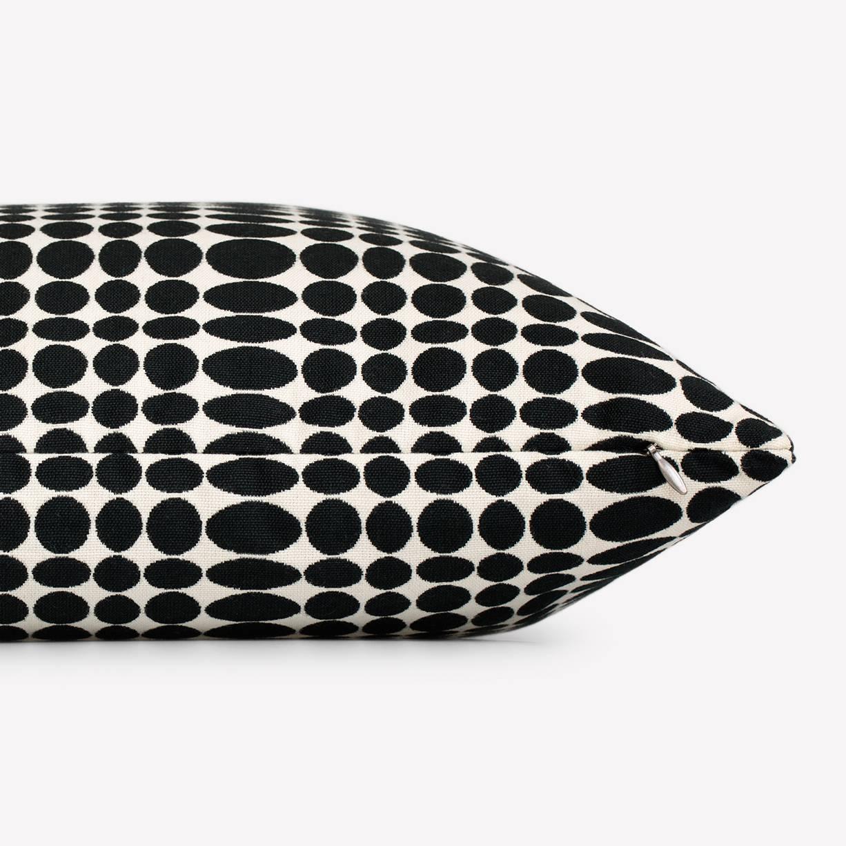 Maharam pillow
Unisol by Verner Panton
001 black/white

Created by Verner Panton in 1965, Unisol is a graphic pattern featuring rows of black ellipses on a white round. The ellipses are compressed in width at rhythmic intervals, creating an optical