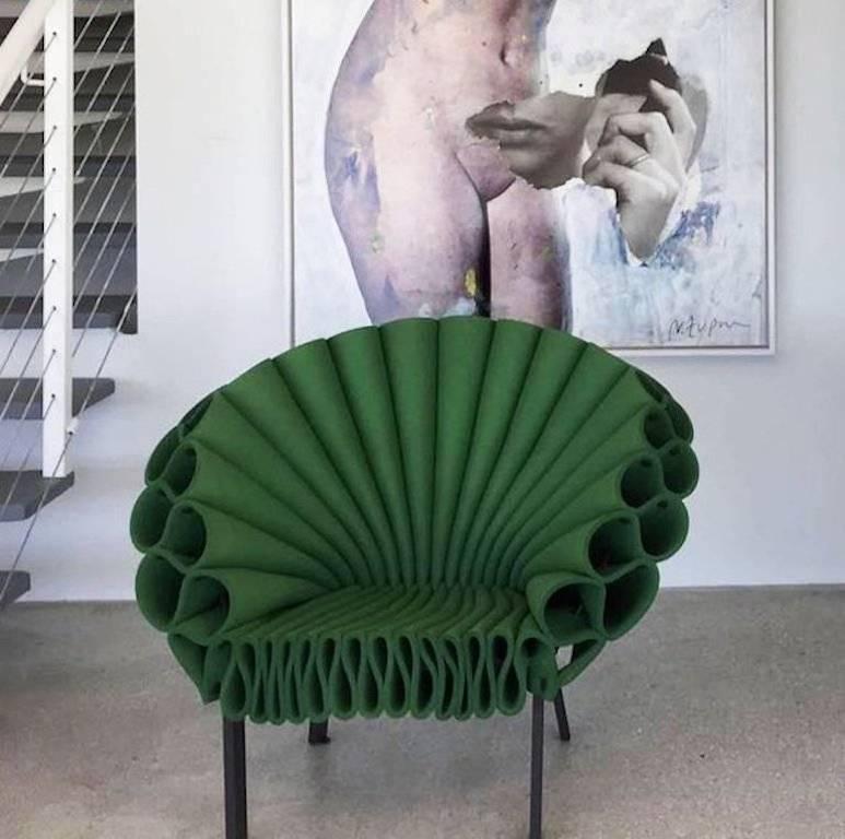 Armchair available in green and blue 

This armchair was designed by Israeli artist Dror Benshetrit for the famous Italian house Cappellini.
The armchair is constructed of mono-chromatic crumpled sheets of felt. It has a metal base, and finished