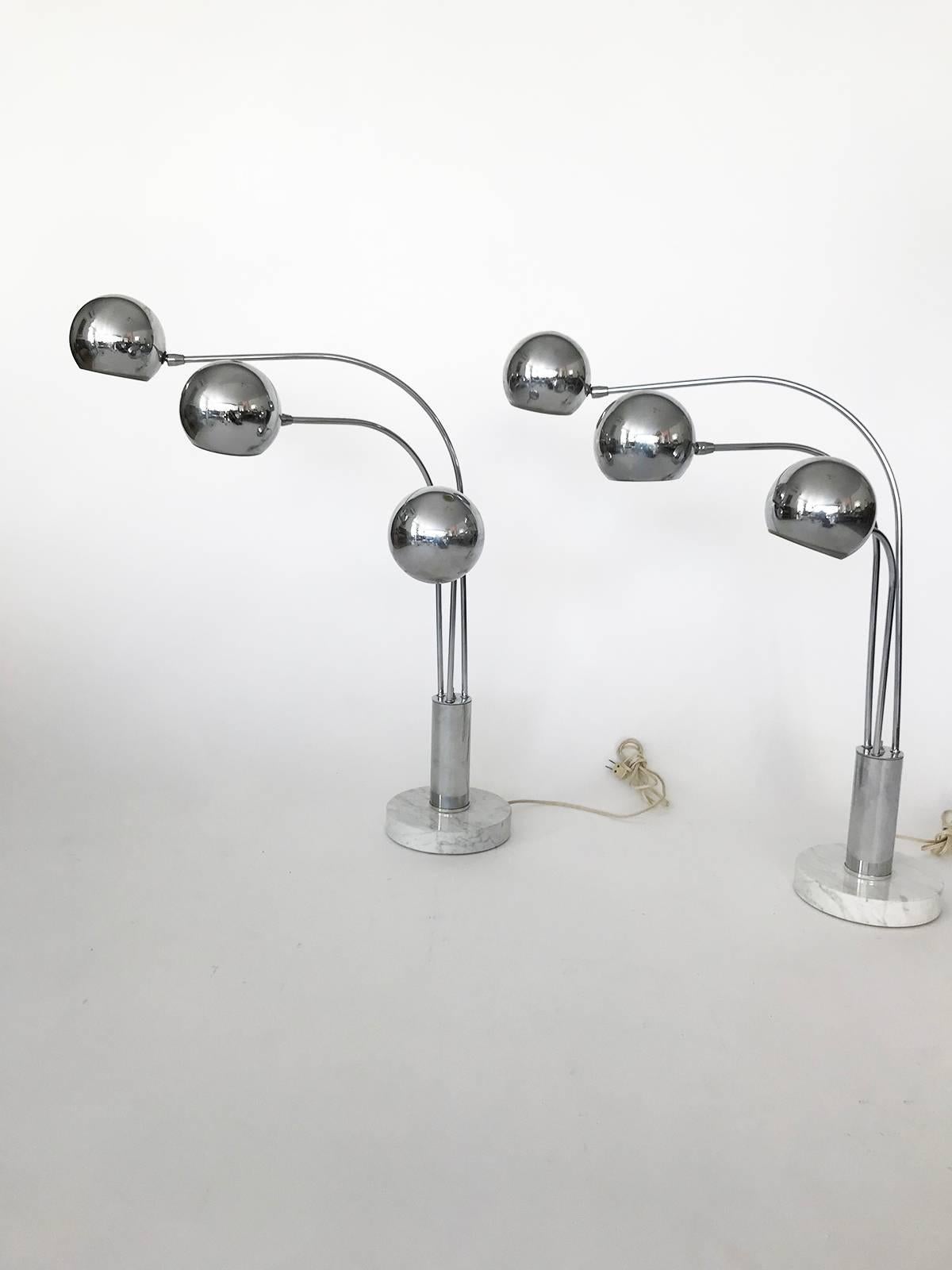 Amazing pair of midcentury chrome orb three-armed lamp with thick heavy white marble base. Sold separately. Listing is for one-lamp, select two if you want the pair. The arms pivot and the orb heads rotate. Has three settings to turn on different