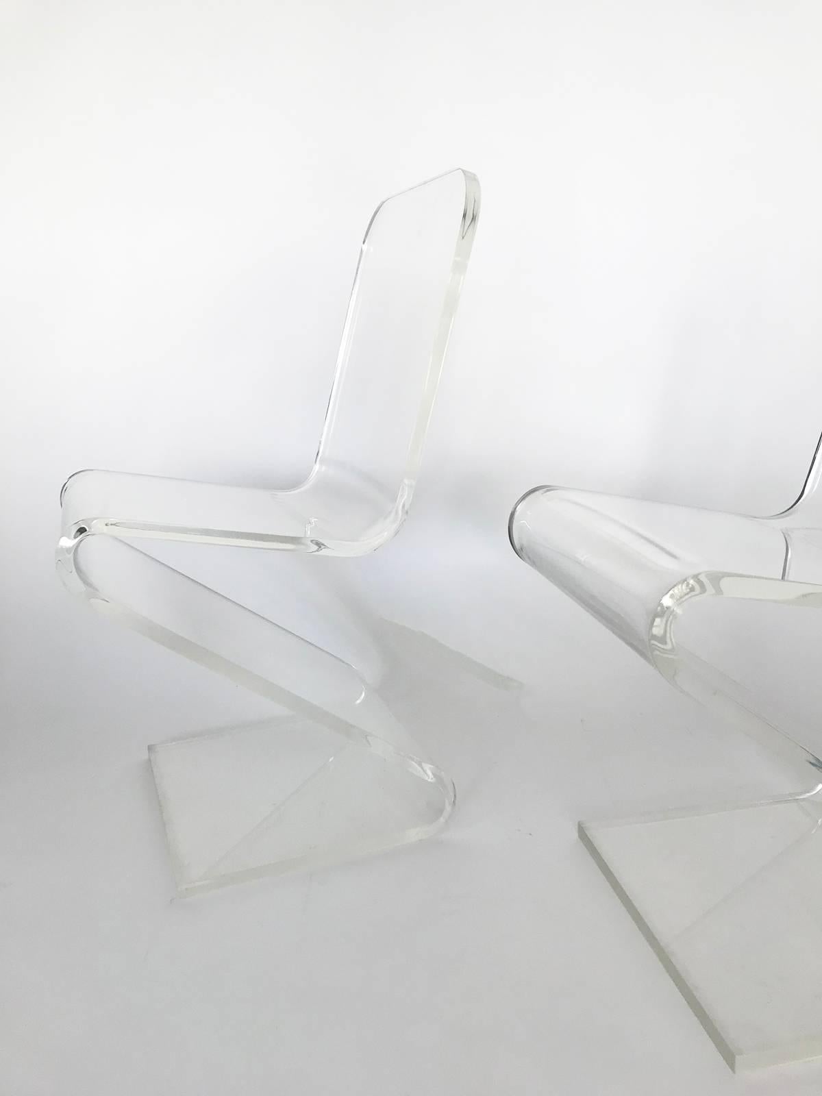 Amazing bent Lucite cantilever Z chairs. Two available. Listed per item. They are in perfect condition, hard to believe they are from 1978. We have original paper work. Signed on bottom base of both chairs. Heavy thick bent Lucite, also very