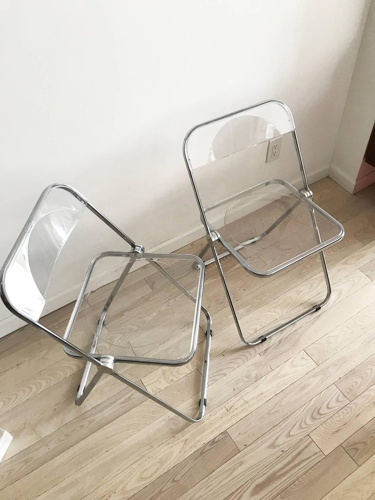 Awesome 1960s Lucite and chrome folding chairs. In amazing condition. Made in Italy. Giancarlo Piretti for Anonima Castelli. Sold as a pair of two chairs.