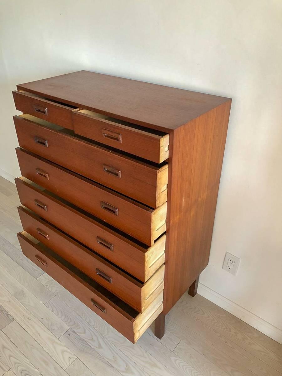 Danish midcentury teak tallboy dresser chest of drawers, 1960. A beautiful and timeless Danish teakwood tallboy with seven drawers. Dovetail construction, and sturdy as can be. Super pretty square legs. A true beauty. Very minimal wear.

Measure: