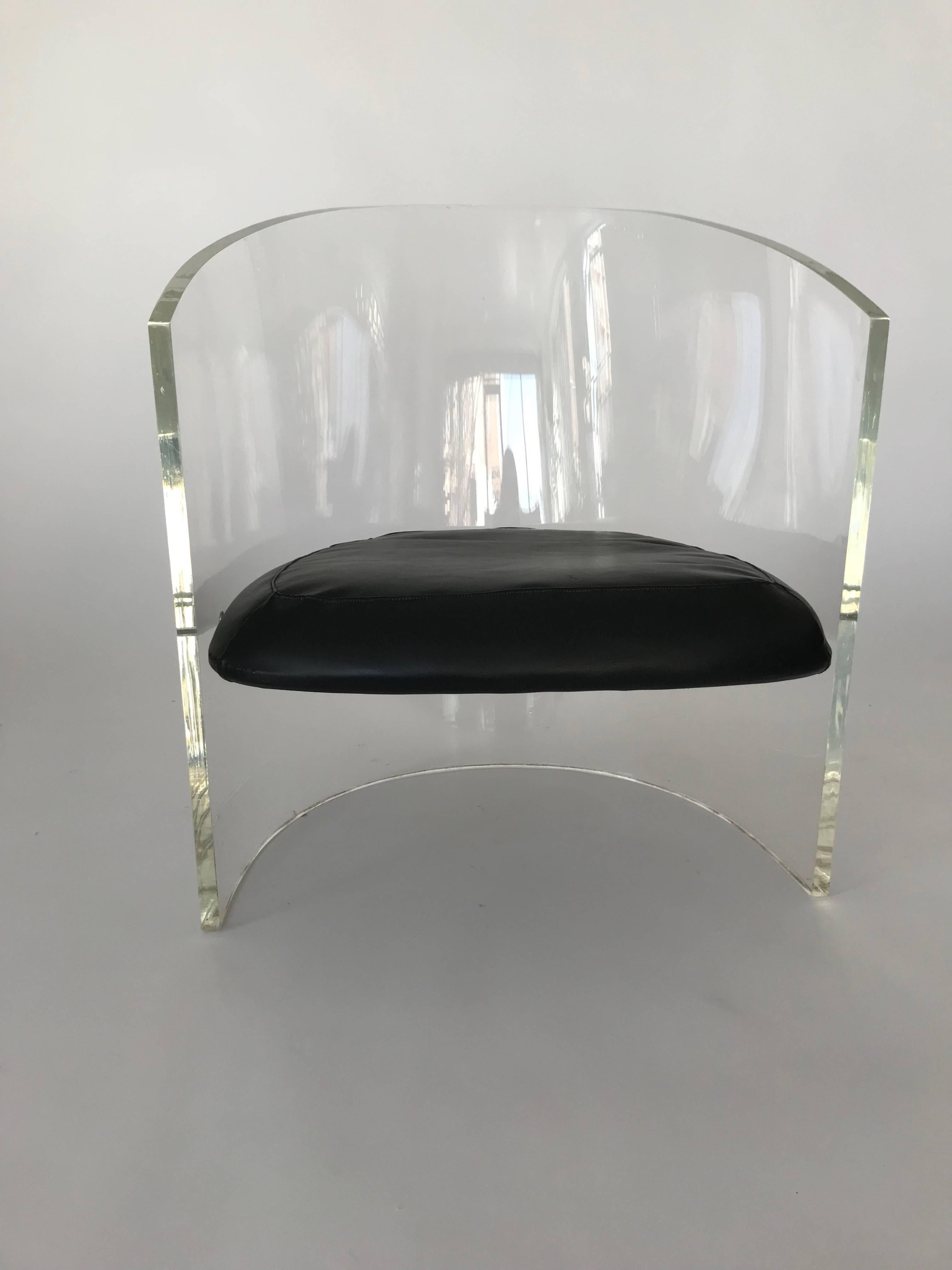 Very cool Lucite barrel chair attributed to Vladimir Kagan. Black vinyl seat. Very minor scuffs and scratches in the Lucite. Chrome hardware. Statement piece.
 