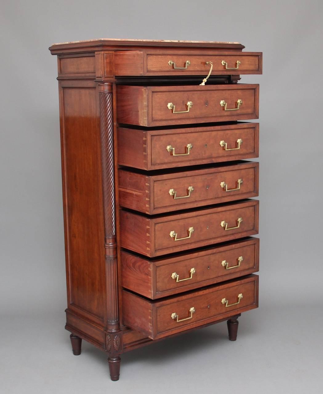A lovely quality 19th century French mahogany semainier chest of drawers, the top having a moulded edge with a fantastic pink and veined figured marble top, with panelled and moulded ends, the chest having seven mahogany lined drawers all with